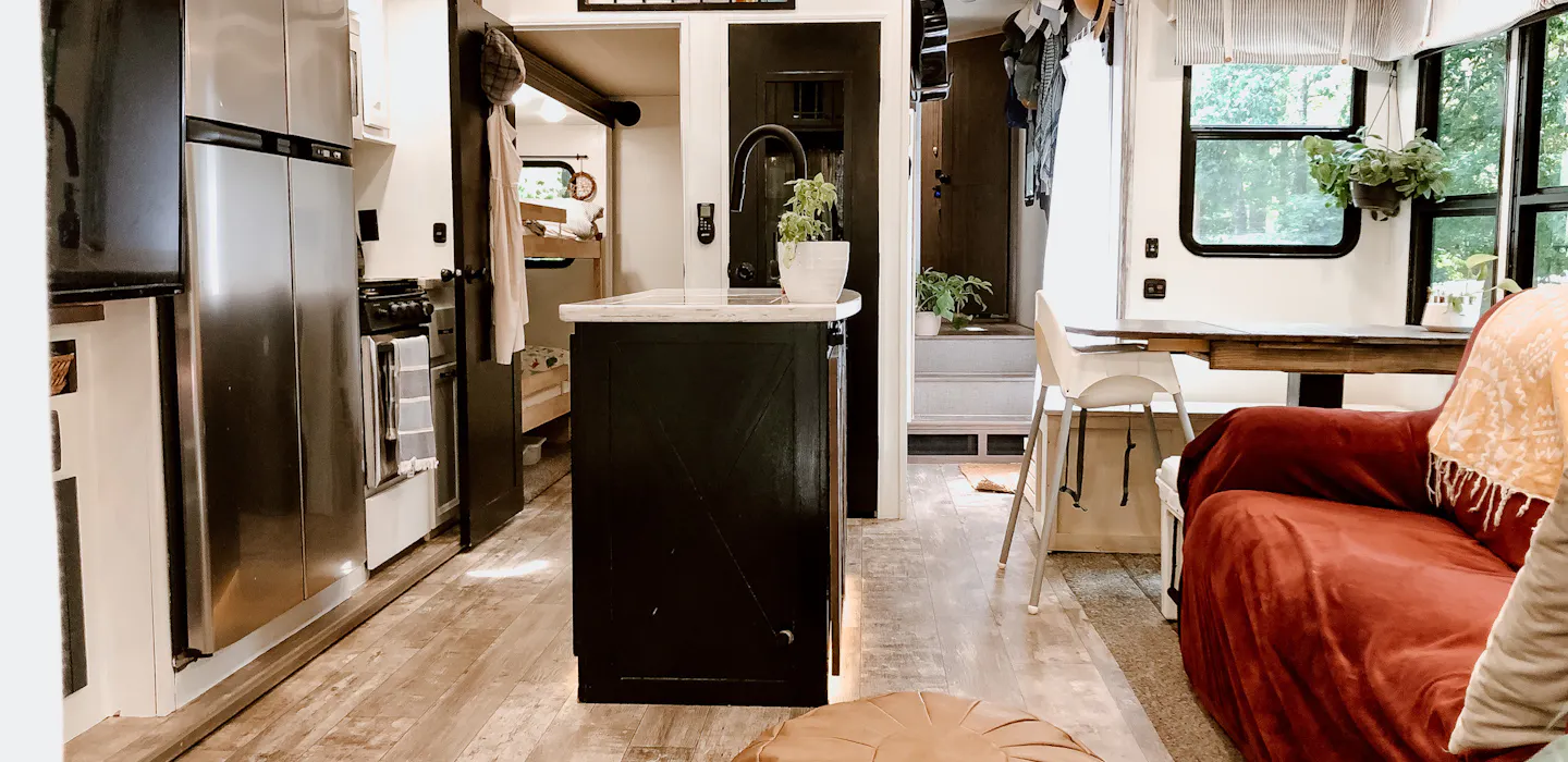 The kitchen, living room, and dining room inside Bibi and JC Barringer's KZ Durango Gold.