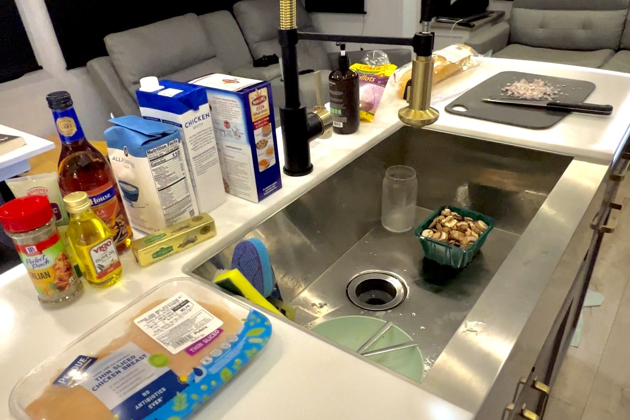 Bailey and Nicole Damberg cooking in their RV kitchen