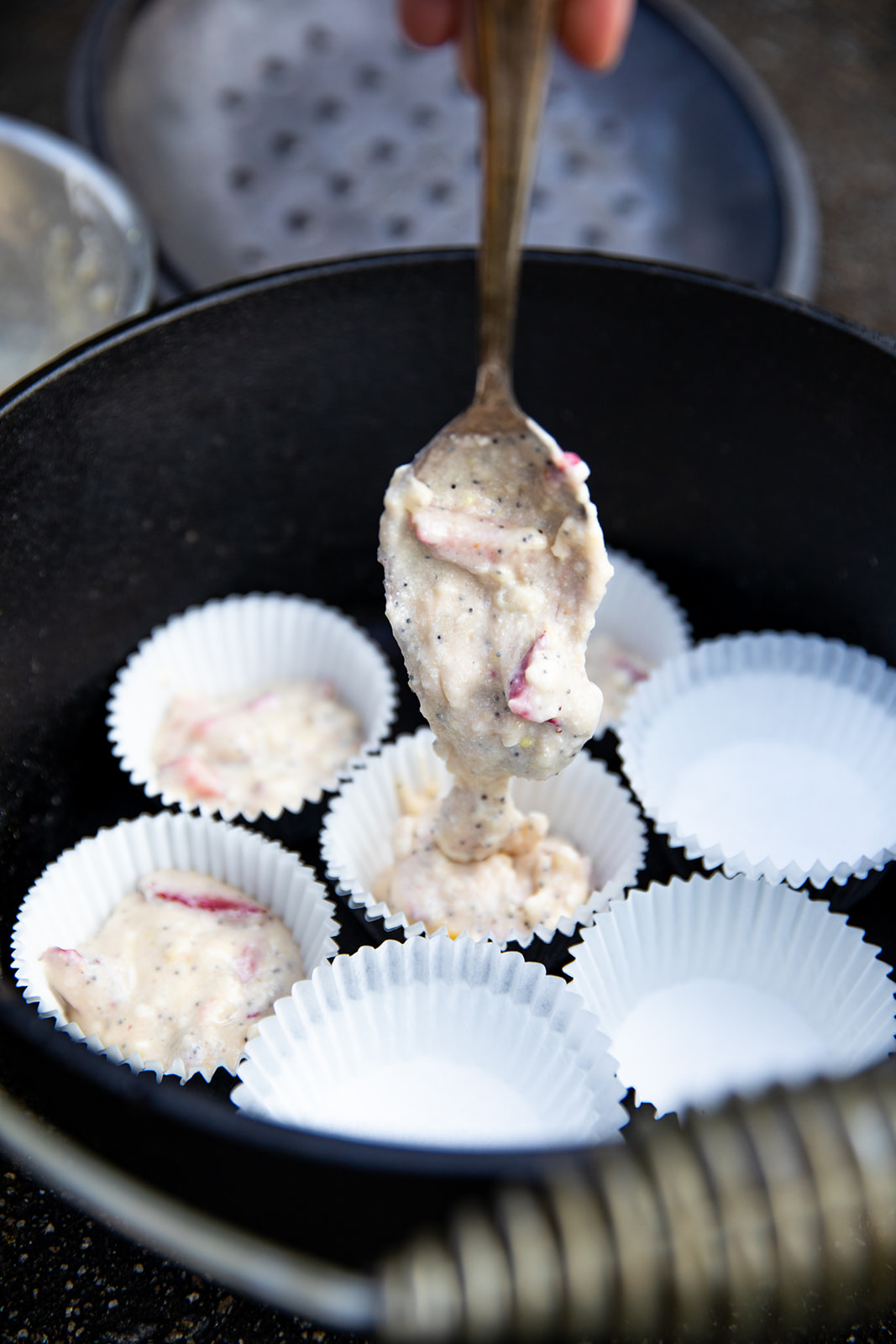 Batter for strawberry corn muffins poured into cups.