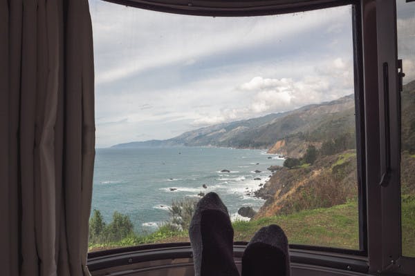 A view of the Big Sur coastline, looking out from an RV window. 
