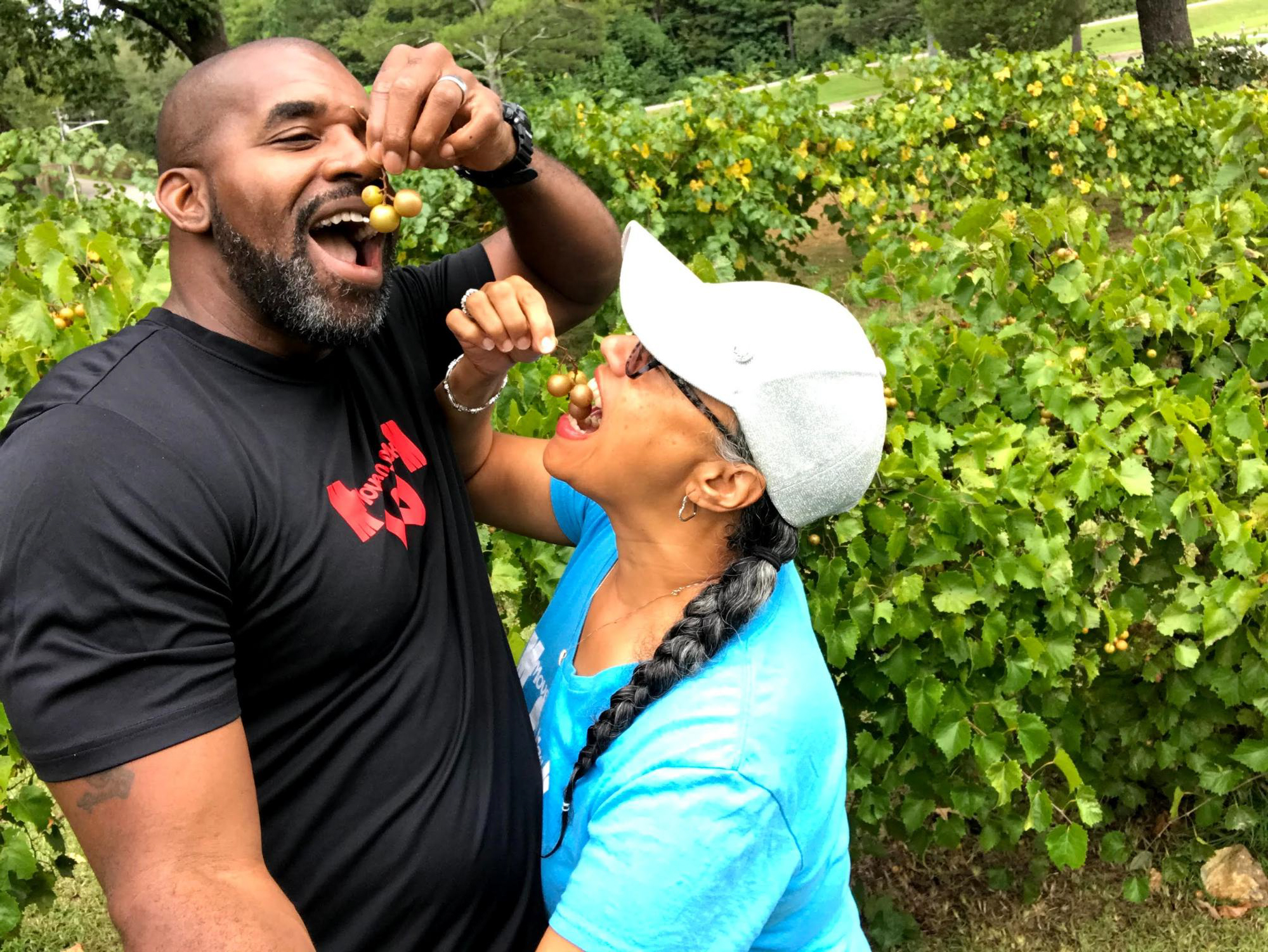 Kirsten Womack and her husband pick grapes and eat them at a park in Leesburg, Alabama. 