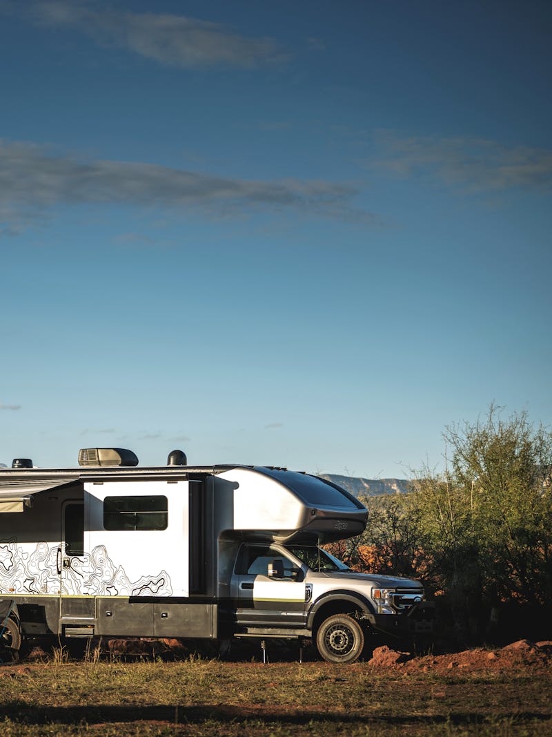 The exterior of a Jayco Seneca Super C (Class C motorhome) parked in a desert landscape