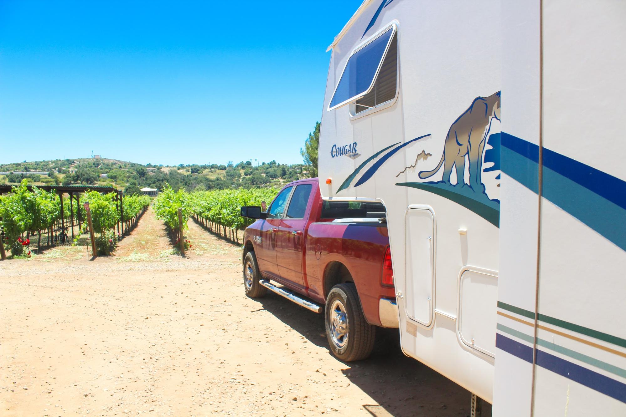 Jesse & Rachael Lyons park their Keystone Cougar RV in front of a vineyard. 
