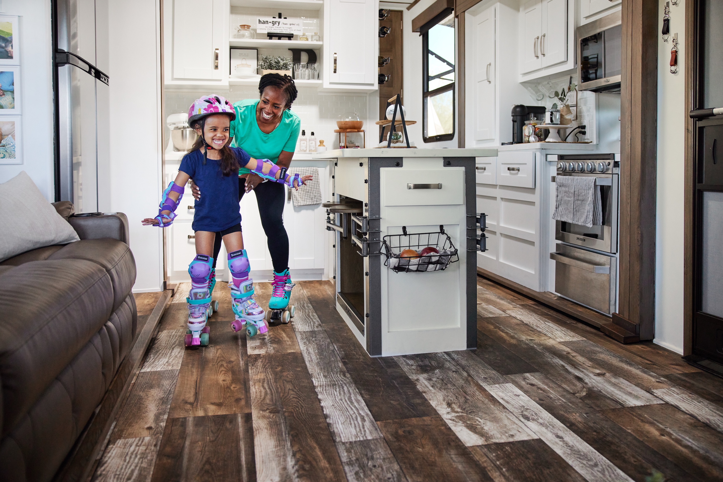 Robin and holds onto her granddaughter as they roller skate around the kitchen of a Keystone Fuzion.