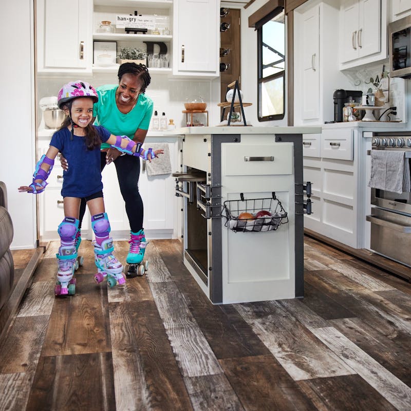 Robin and holds onto her granddaughter as they roller skate around the kitchen of a Keystone Fuzion.