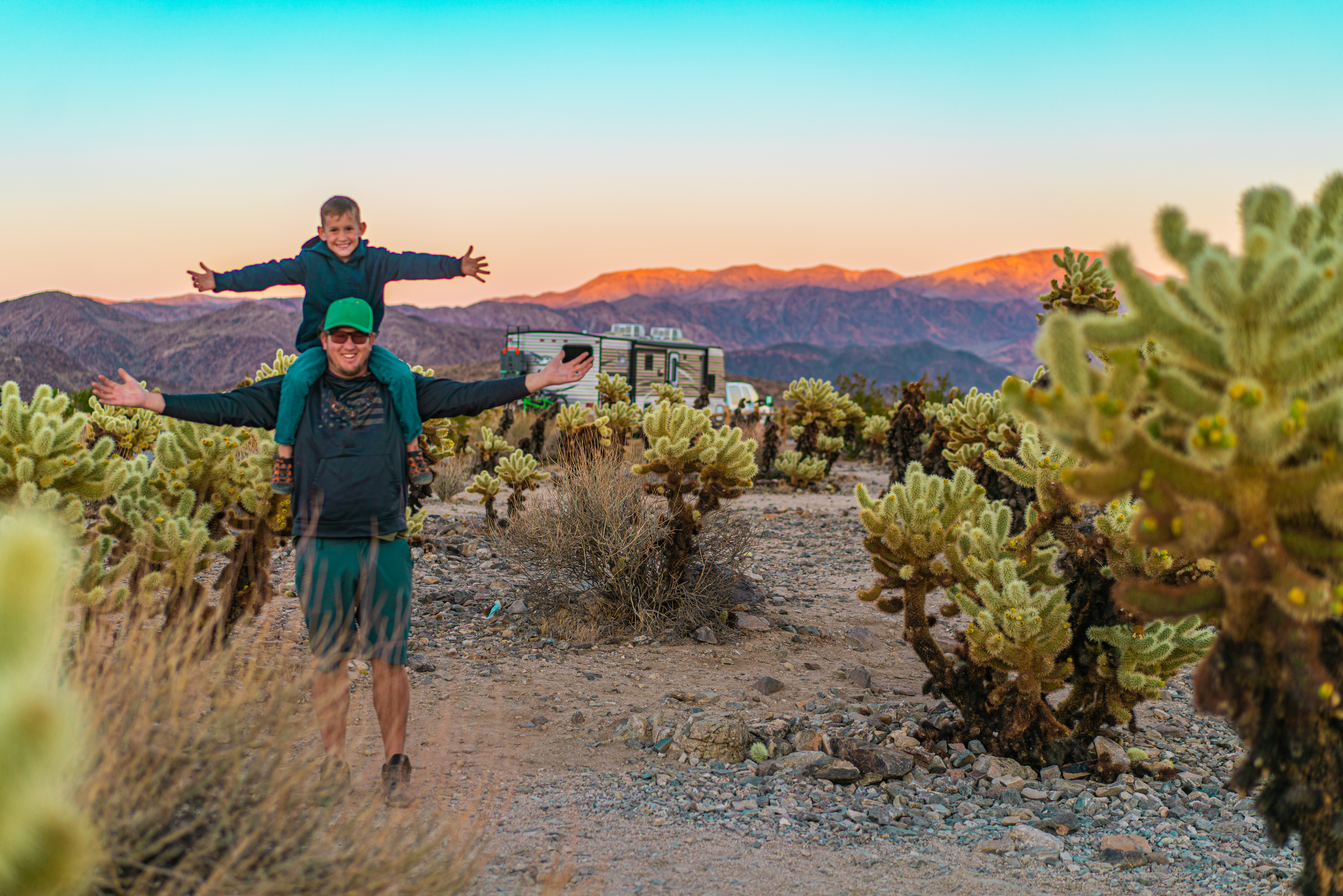 Renee Tilby's husband and her son taking a photo in the desert