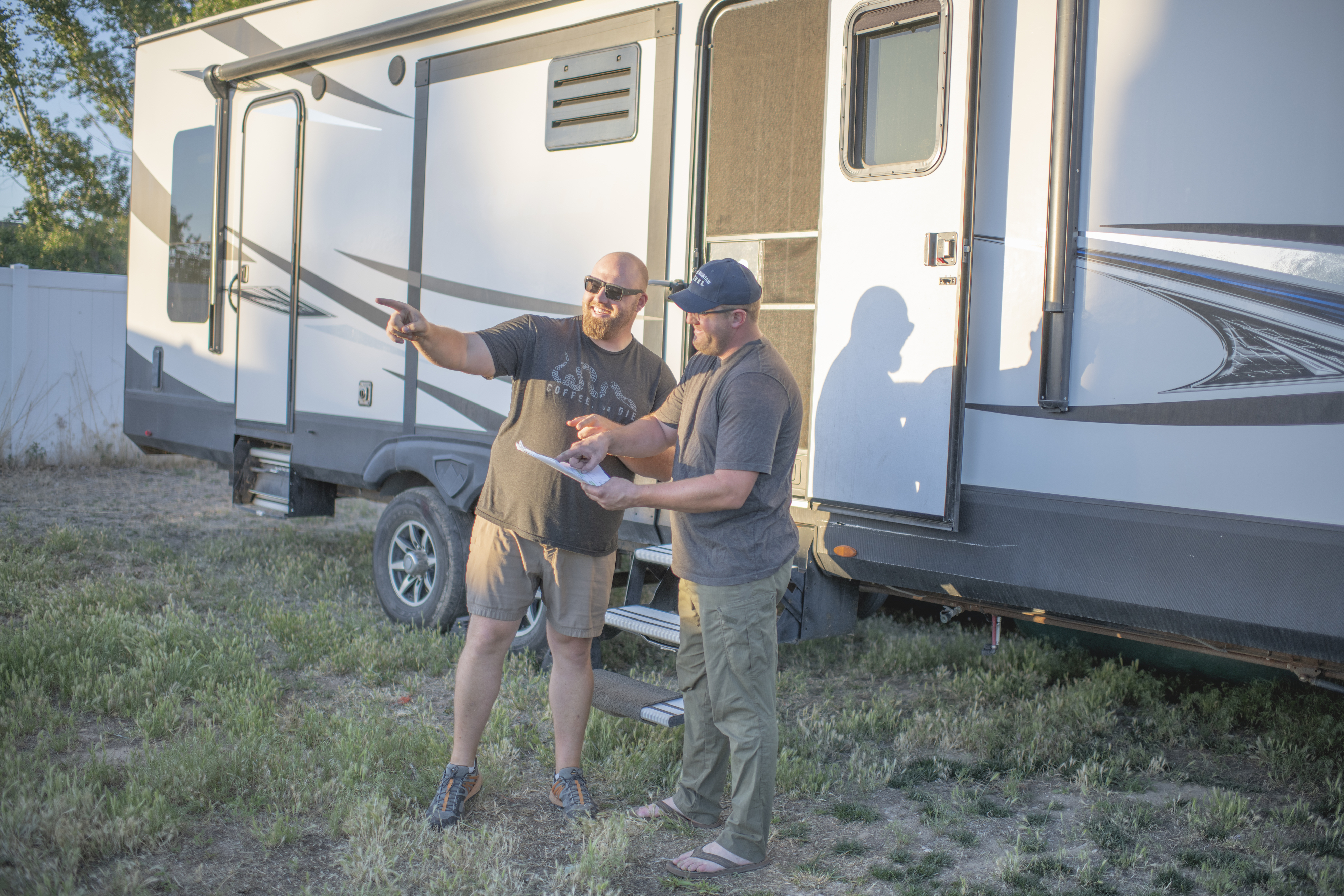 Nate Day talking to another man in front of a Highland Ridge RV