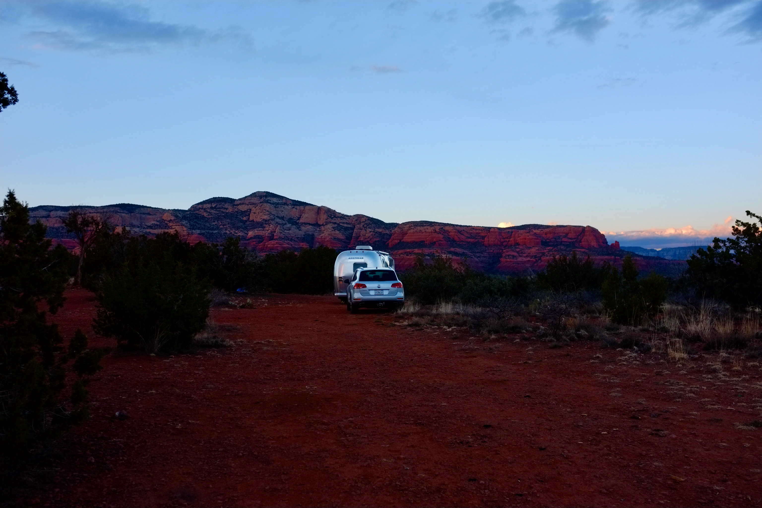 Dr. Na's RV parked at dusk in a desert landscape. 