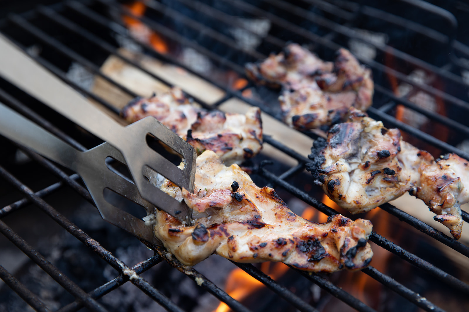 Chicken cooking on a grill.