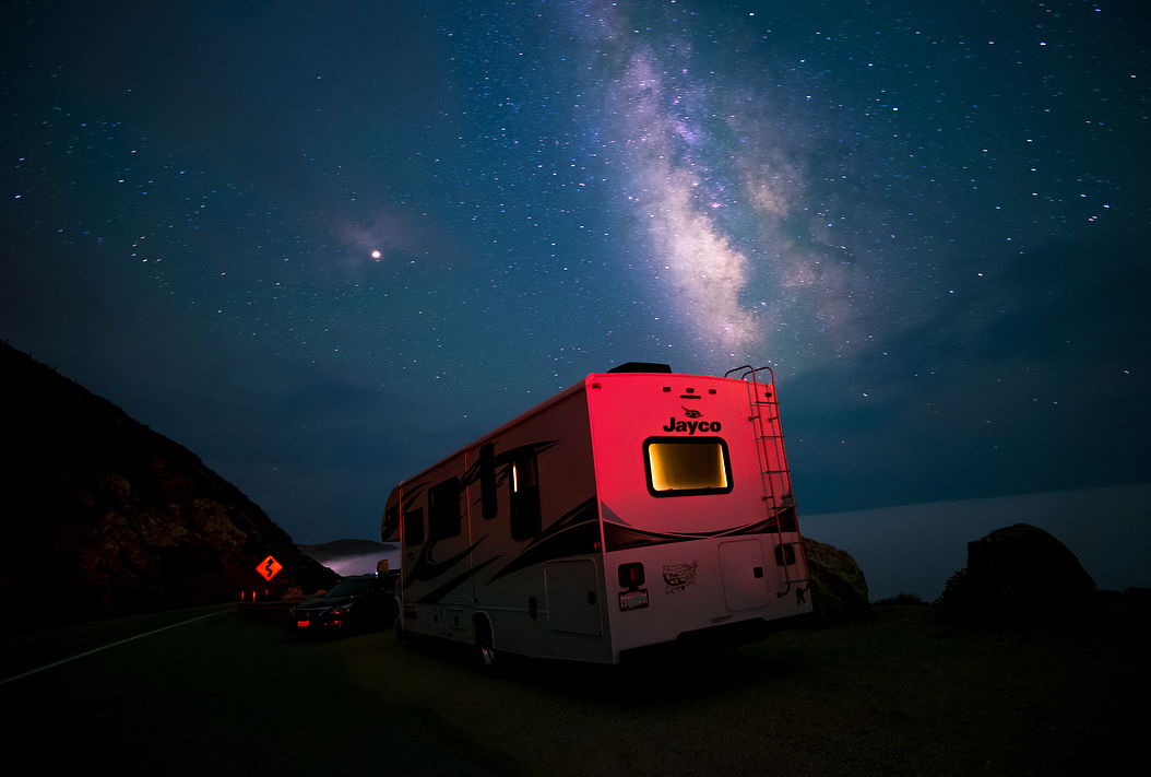 Sandra Peña's Jayco Class C RV parked under a starry sky in California. 