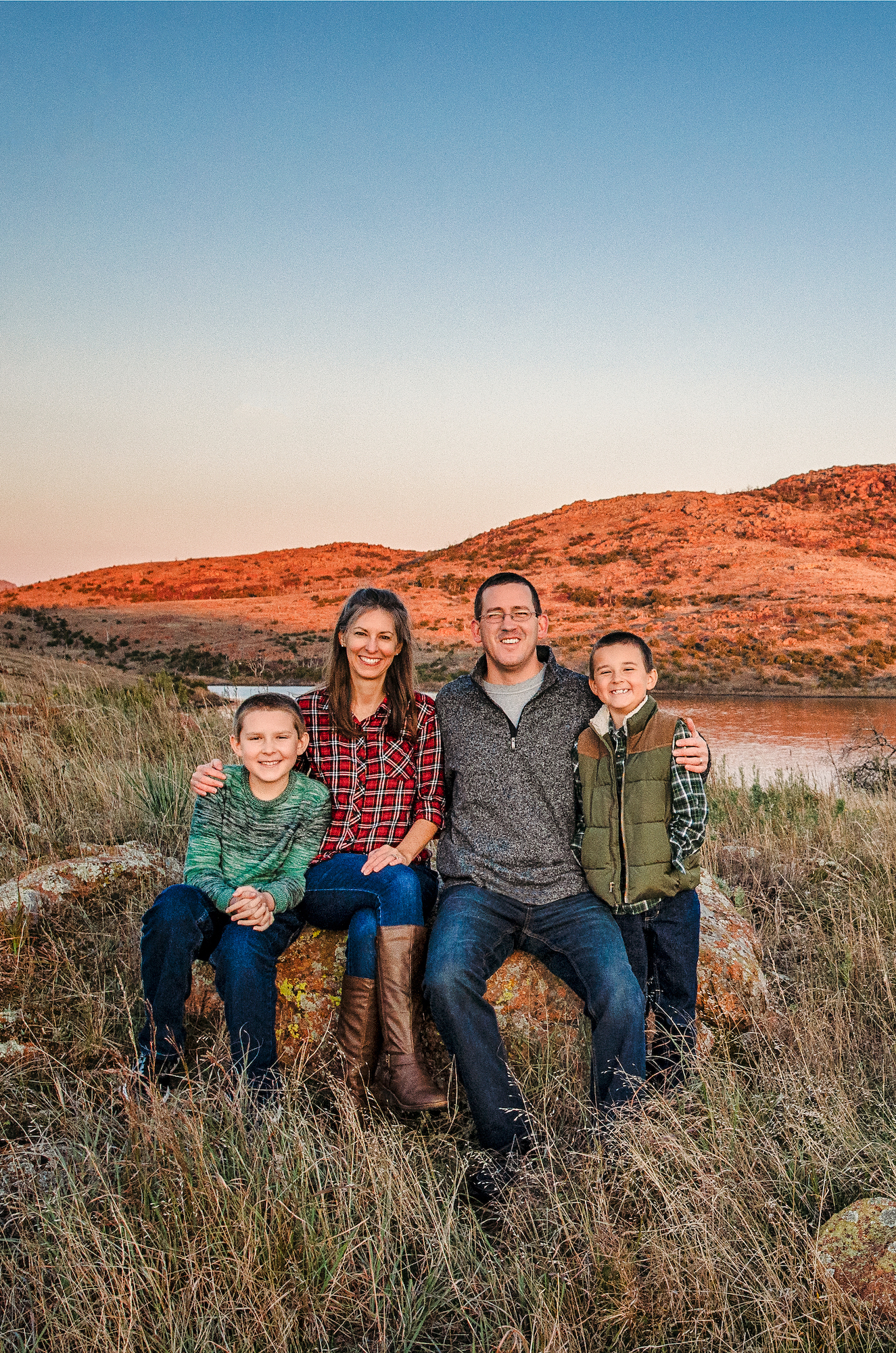 Alison Takacs with her husband and two boys posed in Wichita Mountains, Oklahoma. 
