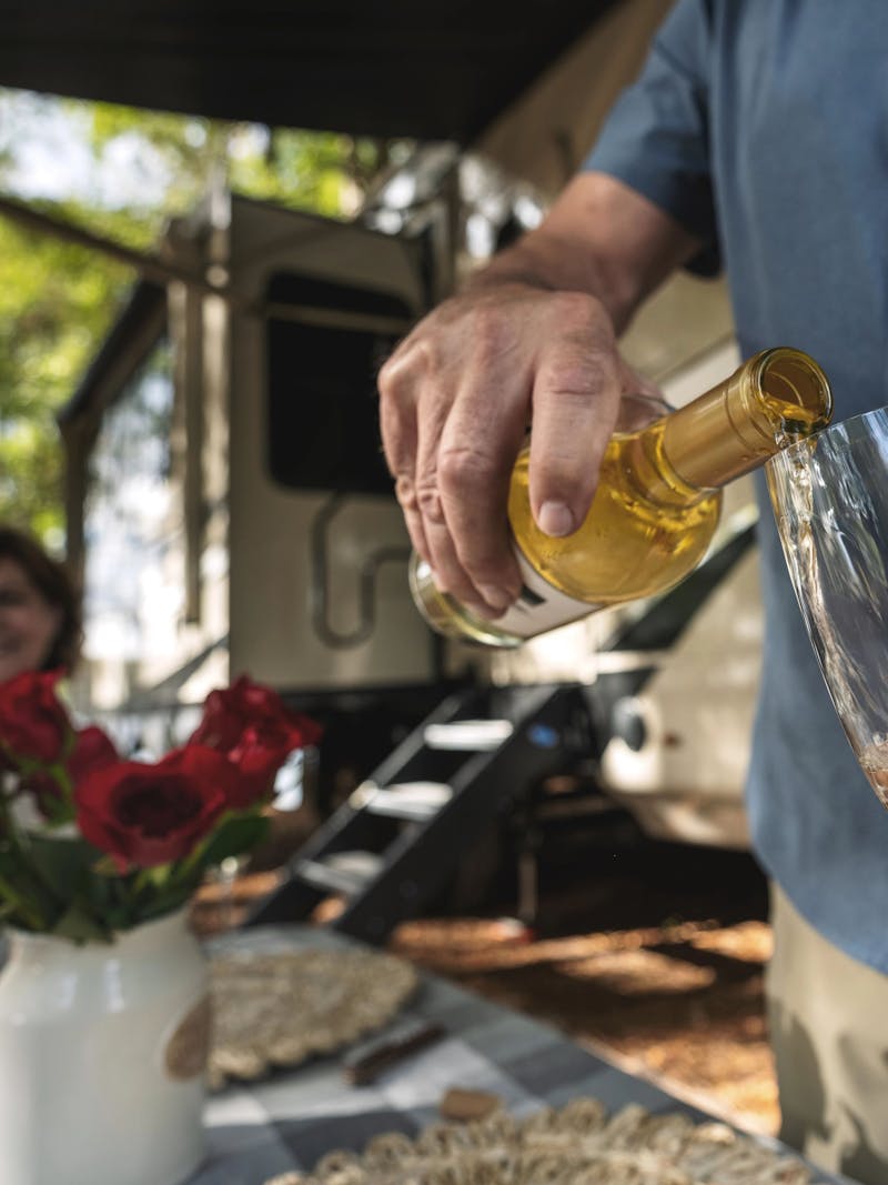 a man pouring a glass of champagne