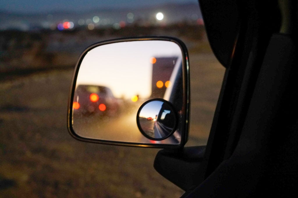 The reflection of RVs through a car's side mirror.