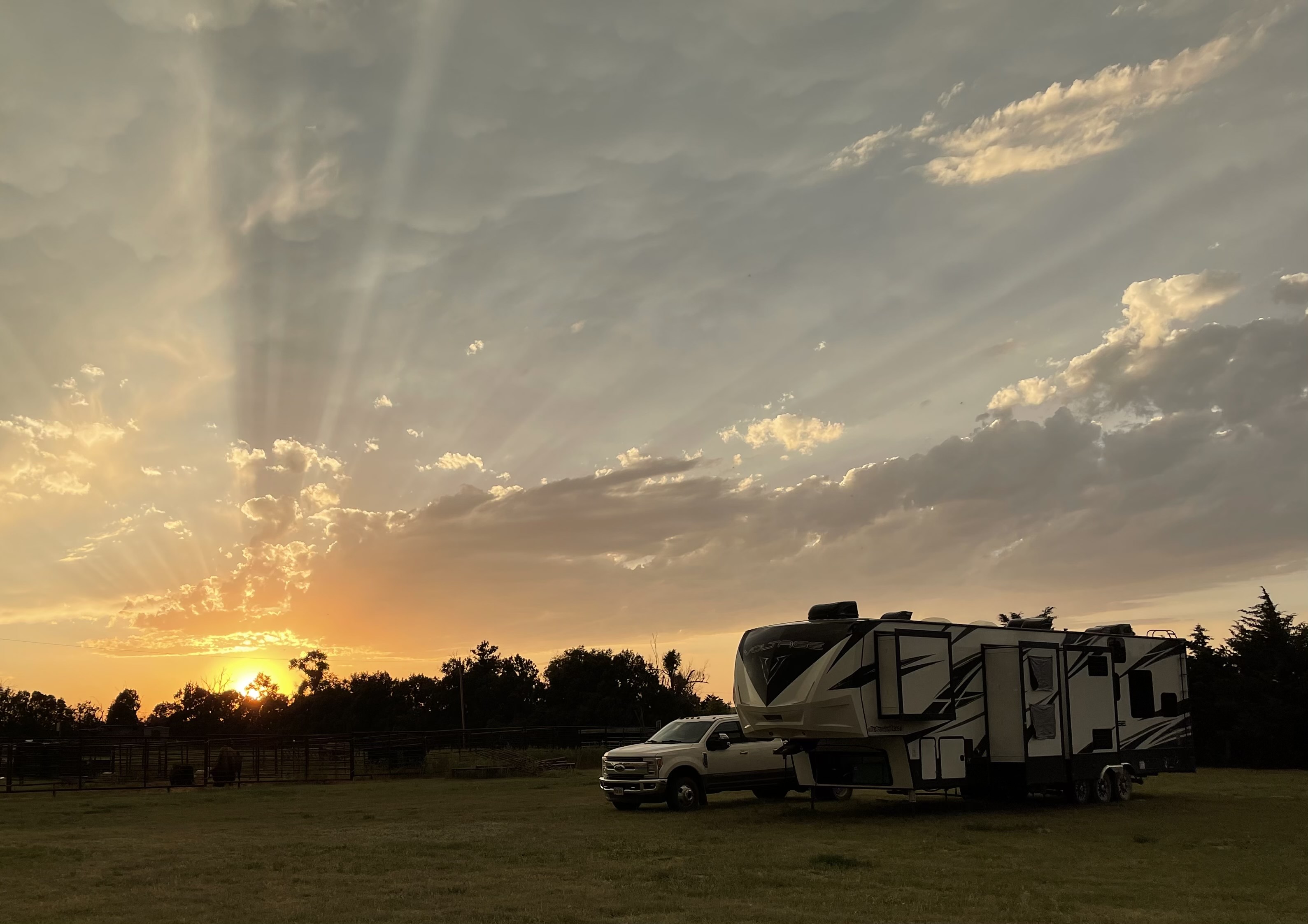 SAMANTHA BADERSCHNEIDER AND BLAKE EDMUNDS rv parked in a field 