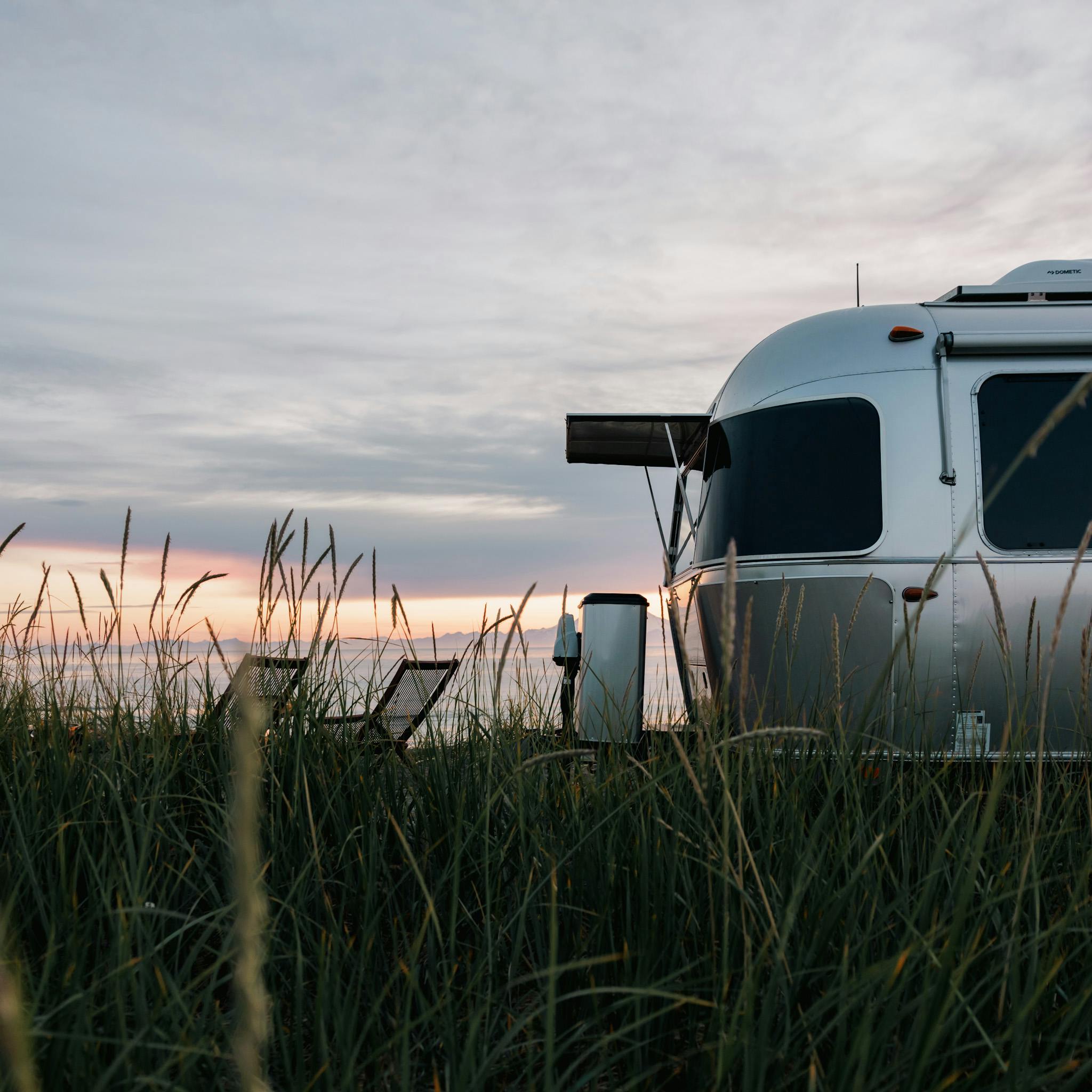 Karen Blue's Airstream by the beach at sunset