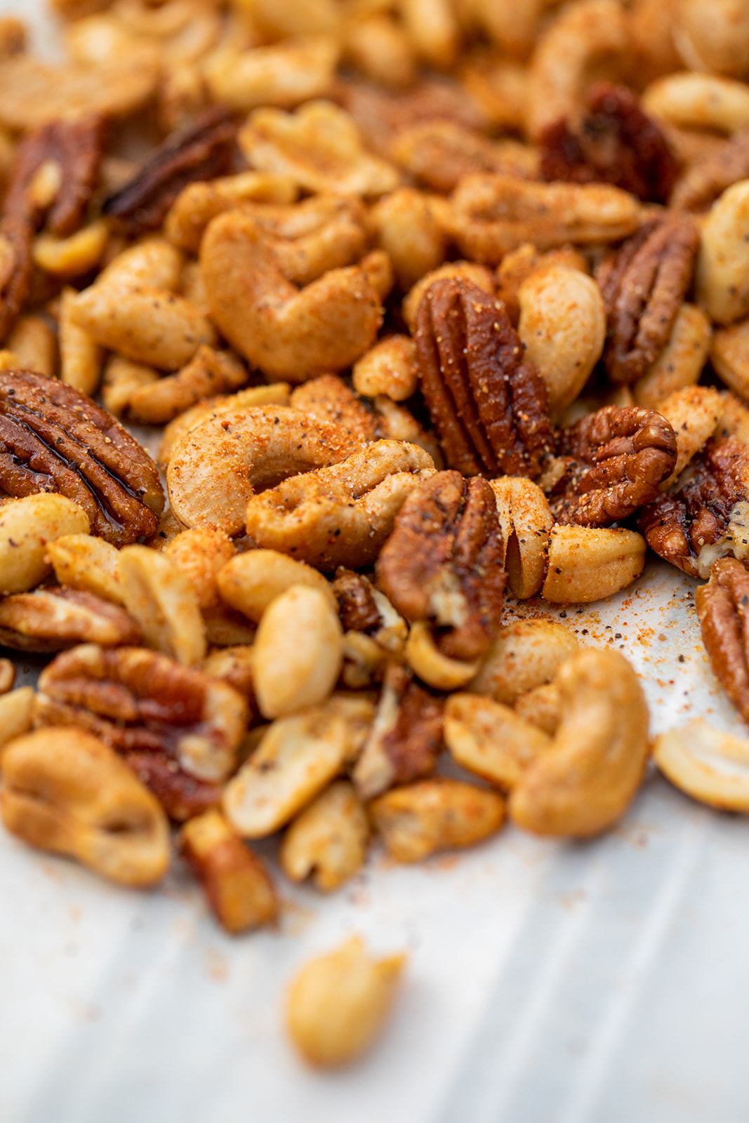 A close up shot of mixed nuts covered in Cajun spices.