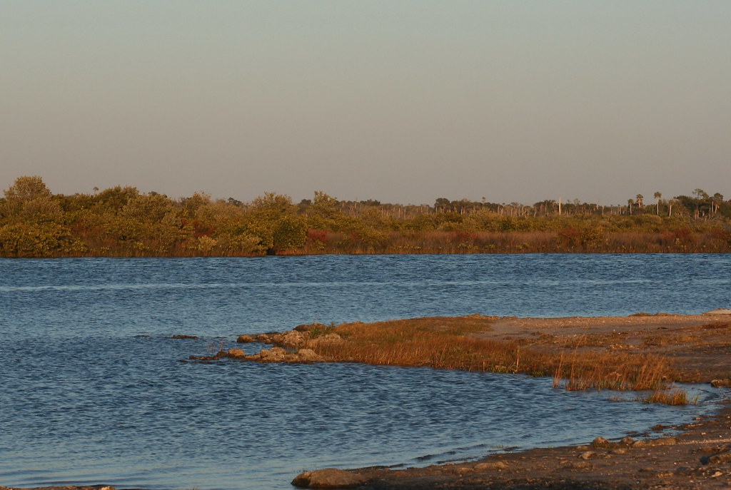 Shores of Ozello Community Park with red-orange grass and blue river