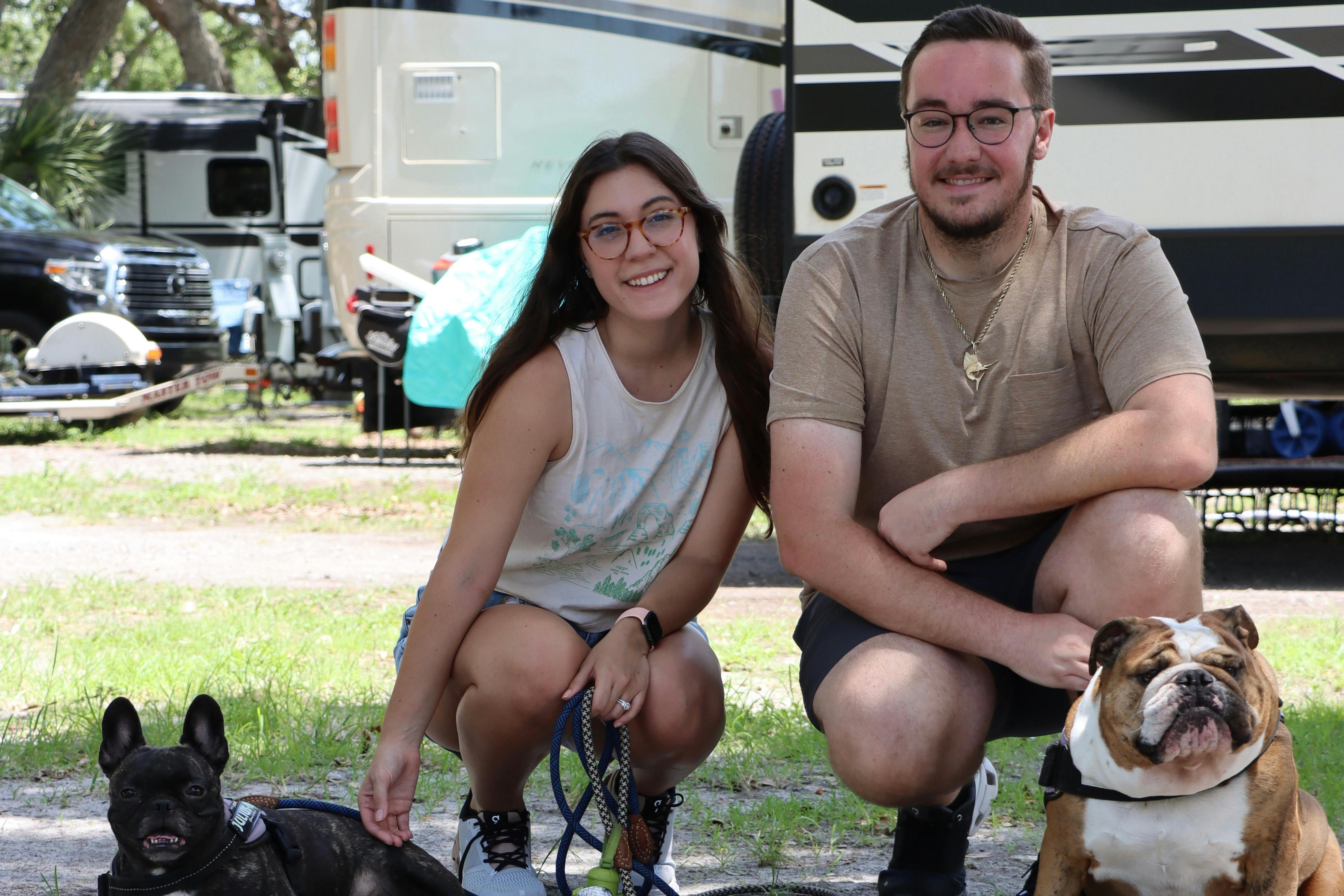 Nicole and Bailey Damberg and their two dogs at a campground.