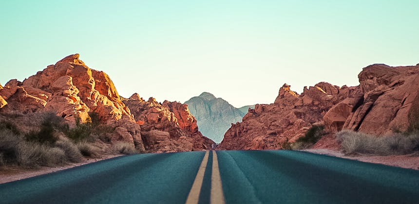 A photo of the road in a rocky desert landscape