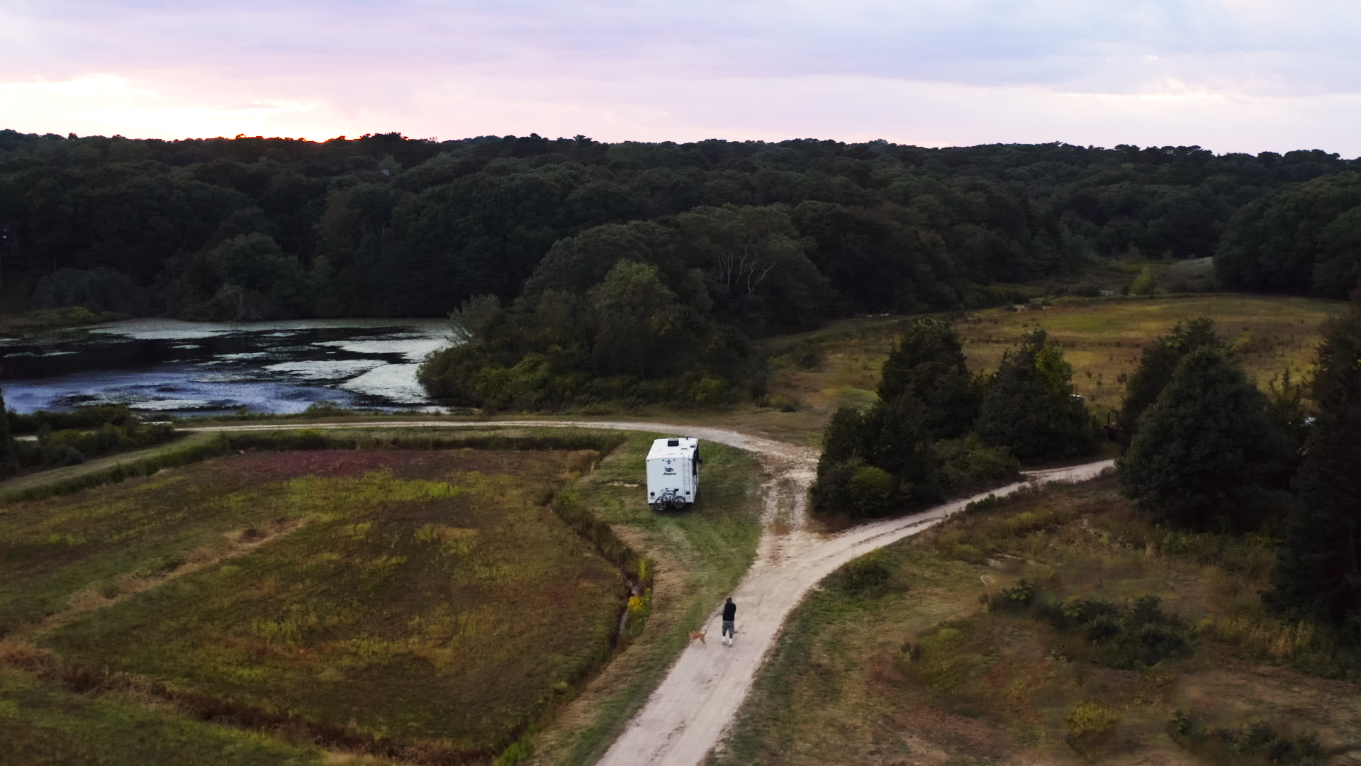 Sonya Lowery and Ray Young take their dog on a walk through the cranberry bog where their RV is parked.