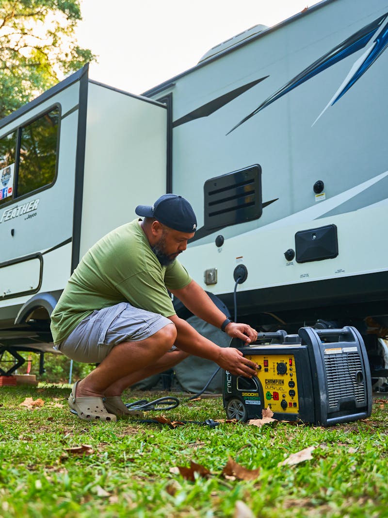 Ben McMillan working with a generator outside of his RV