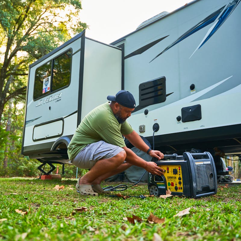 Ben McMillan working with a generator outside of his RV