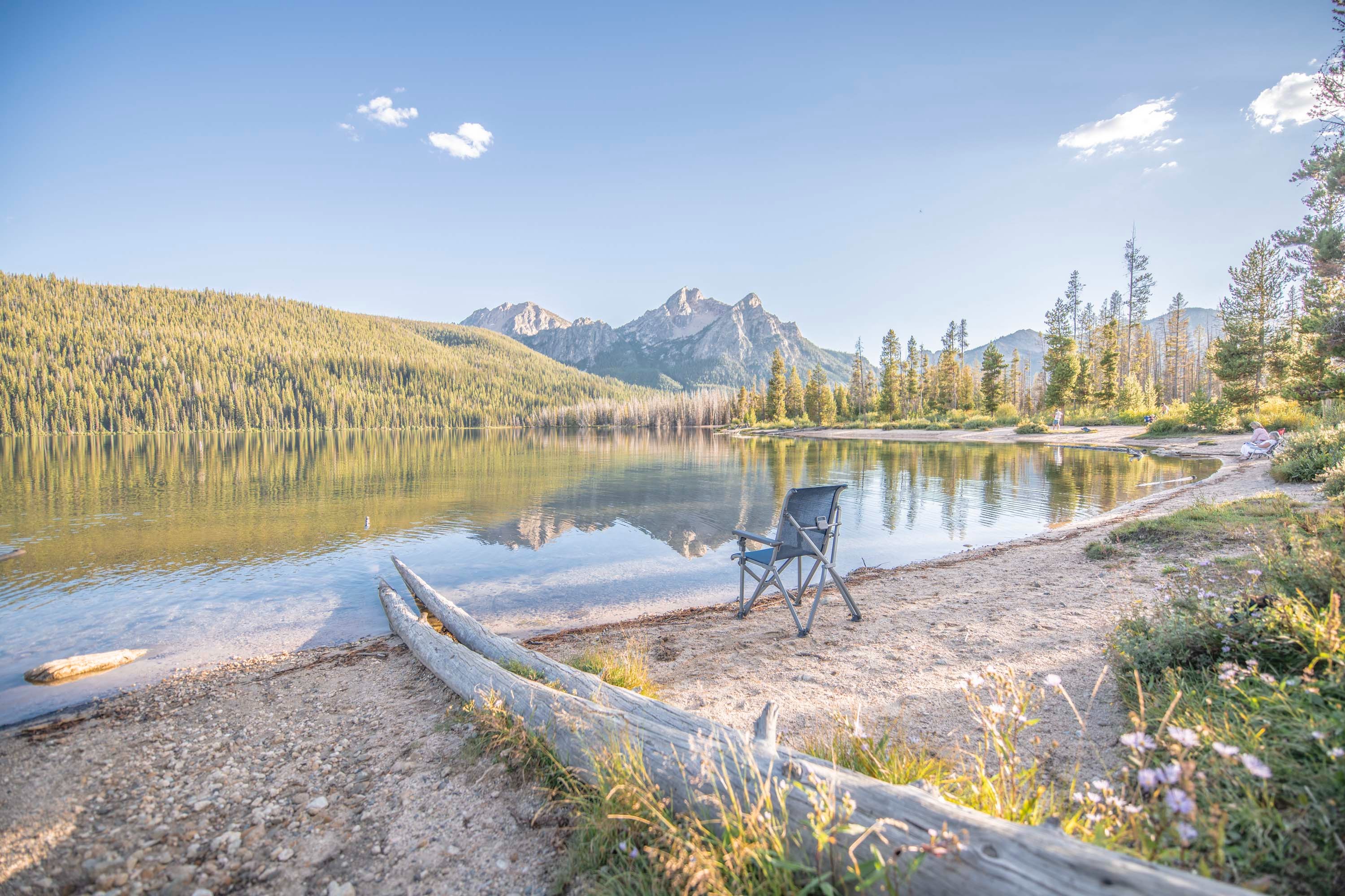 A lake overlooking the mountains at Sawtooth National Forest, captured by Chelsea Day