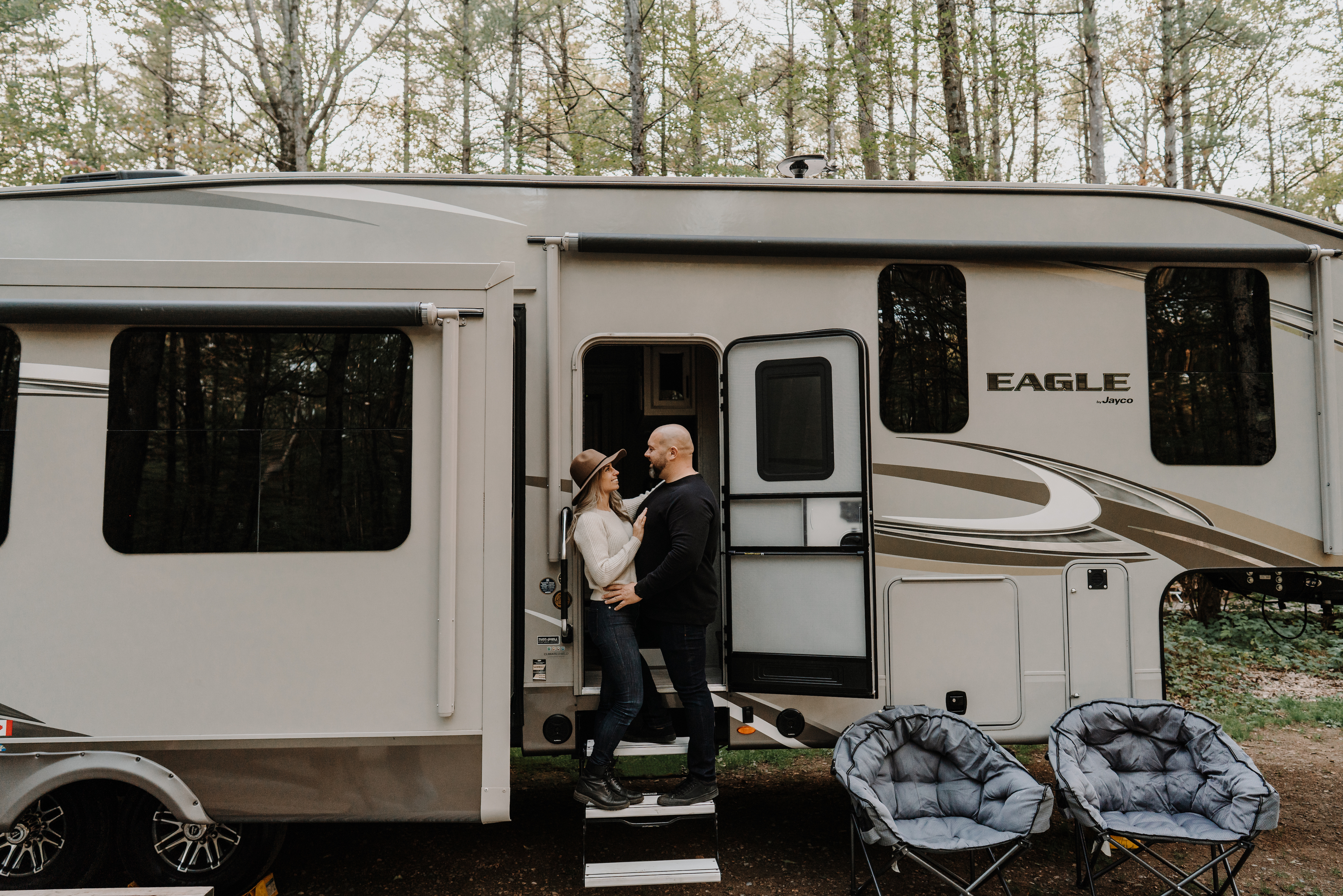 MAX PERRON & MARIE-MICHELLE ROY on the steps of their Jayco Eagle Fifth Wheel RV
