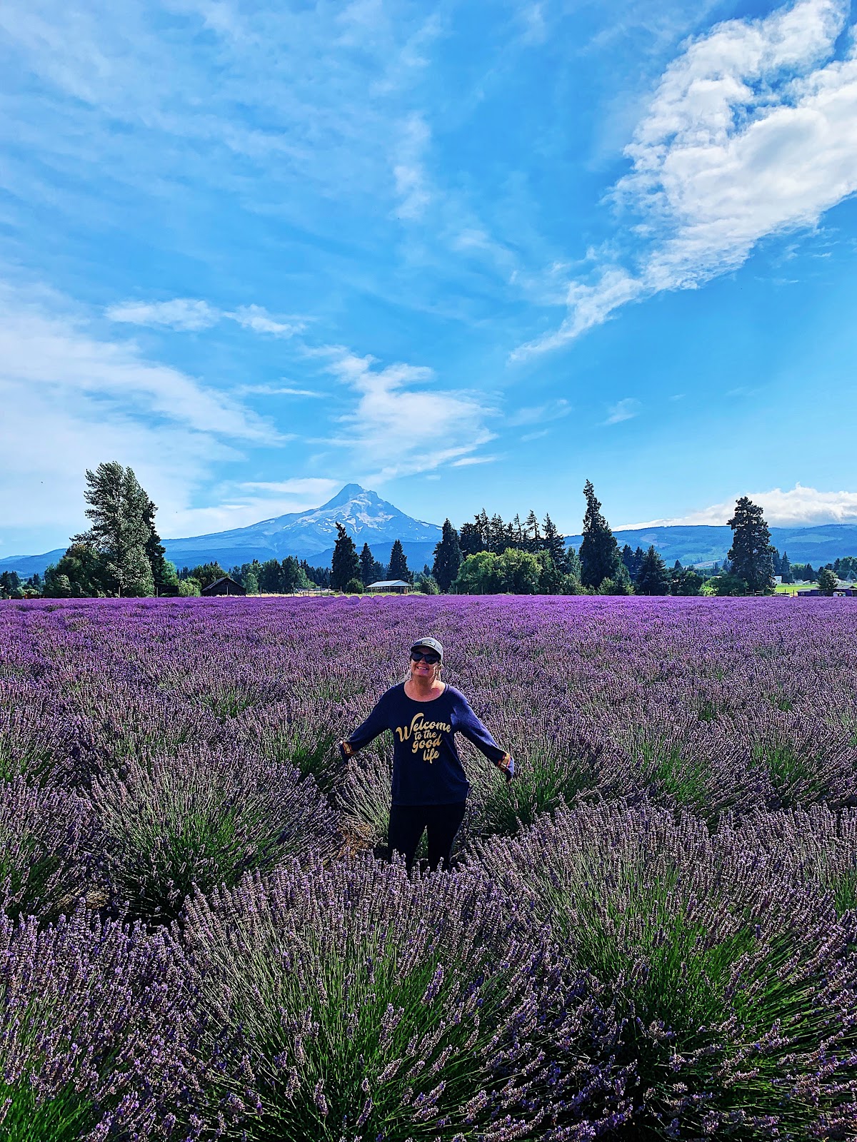 A woman posed in a field of lavender. 