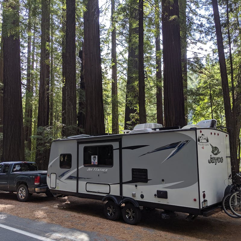 Ben and Christina McMillan's Jayco parked next to tall trees