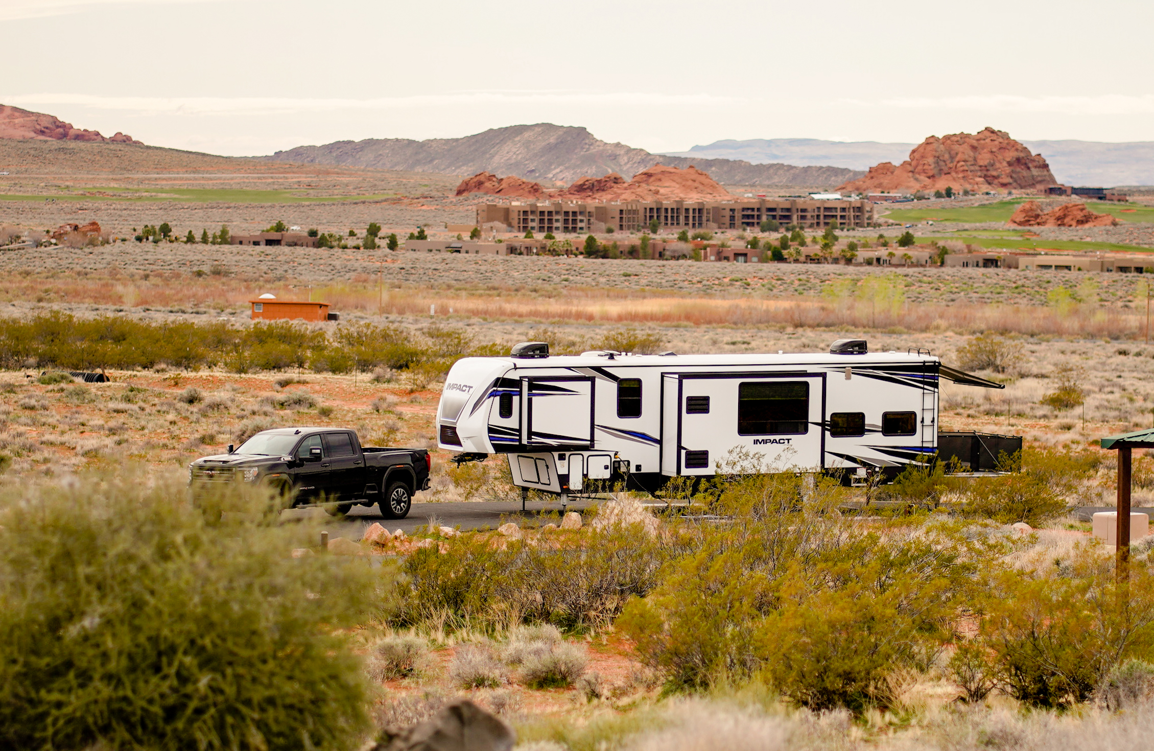 An RV driving through Sand Hallow State Park in Utah.
