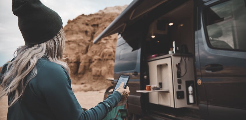 Kale Thorien uses her phone to connect to her TMC Sanctuary Class B RV.