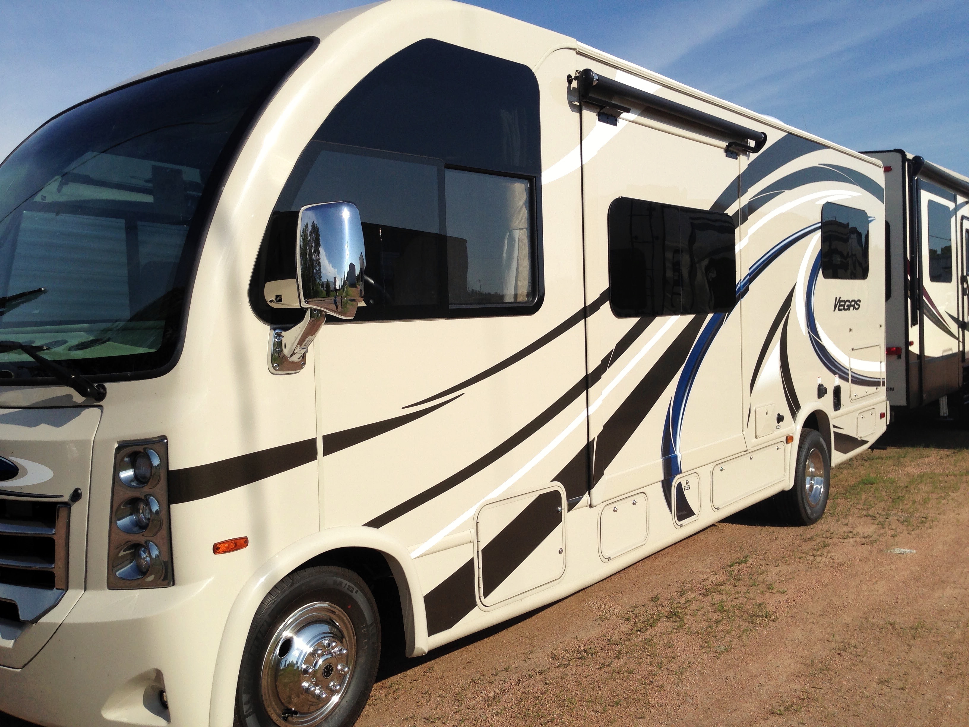 A side shot of a brand new RV.