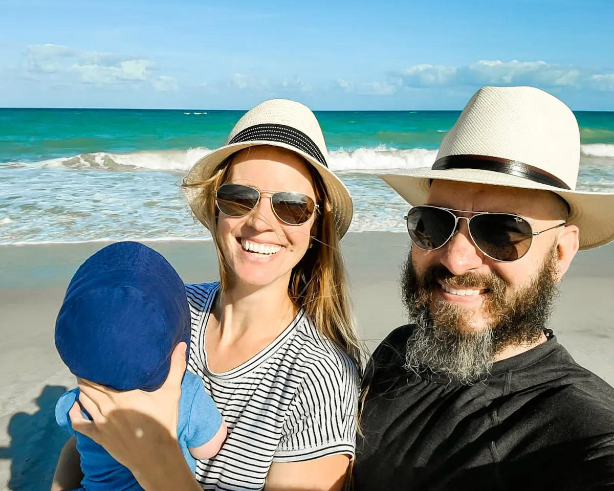 Bibi and JC Barringer and their baby at the beach.