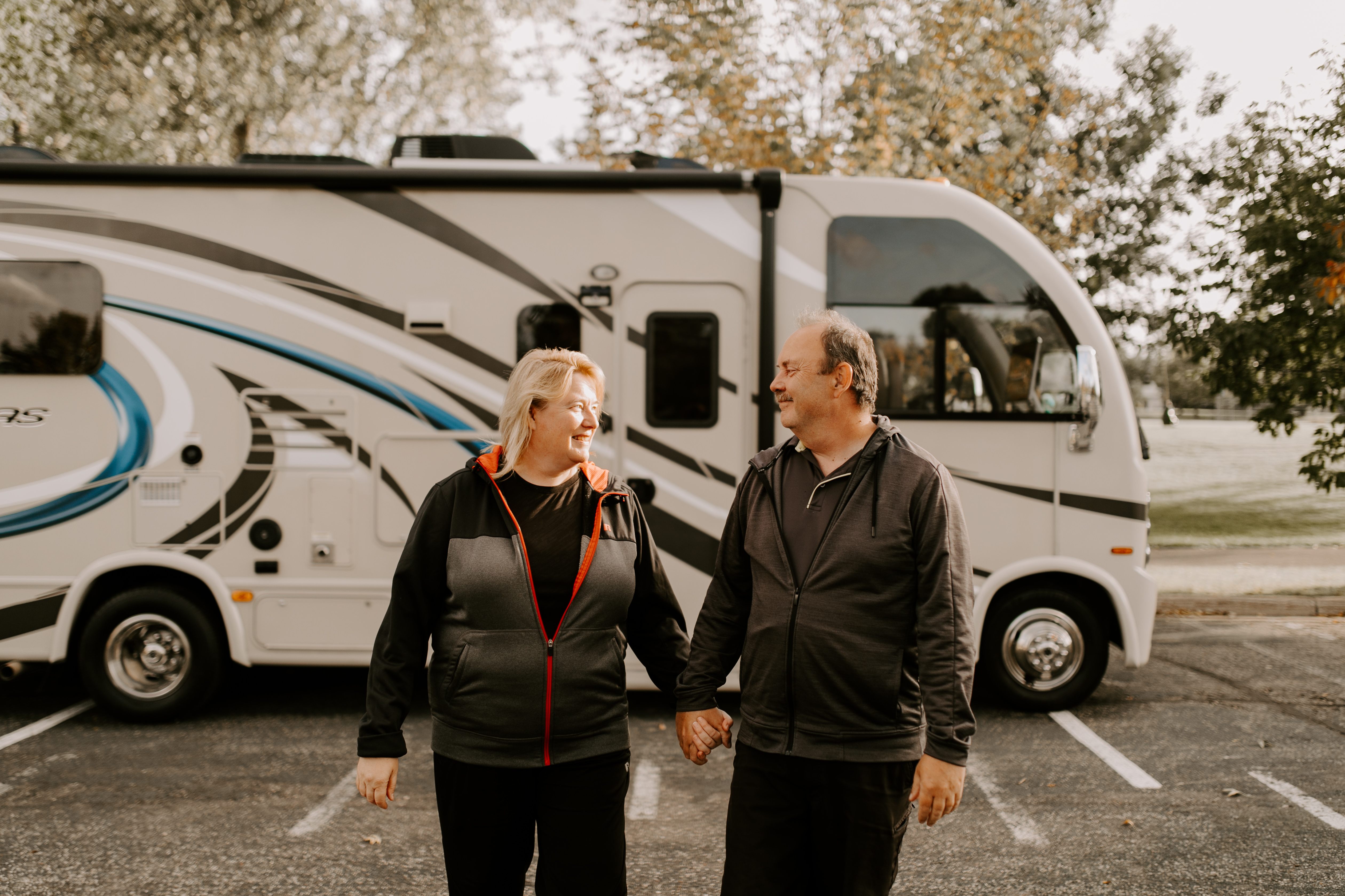 The Bolands holding hands in front of their RV.