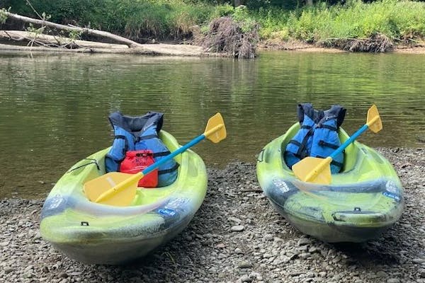 Brandy Gleason's kayaks at the edge of a lake