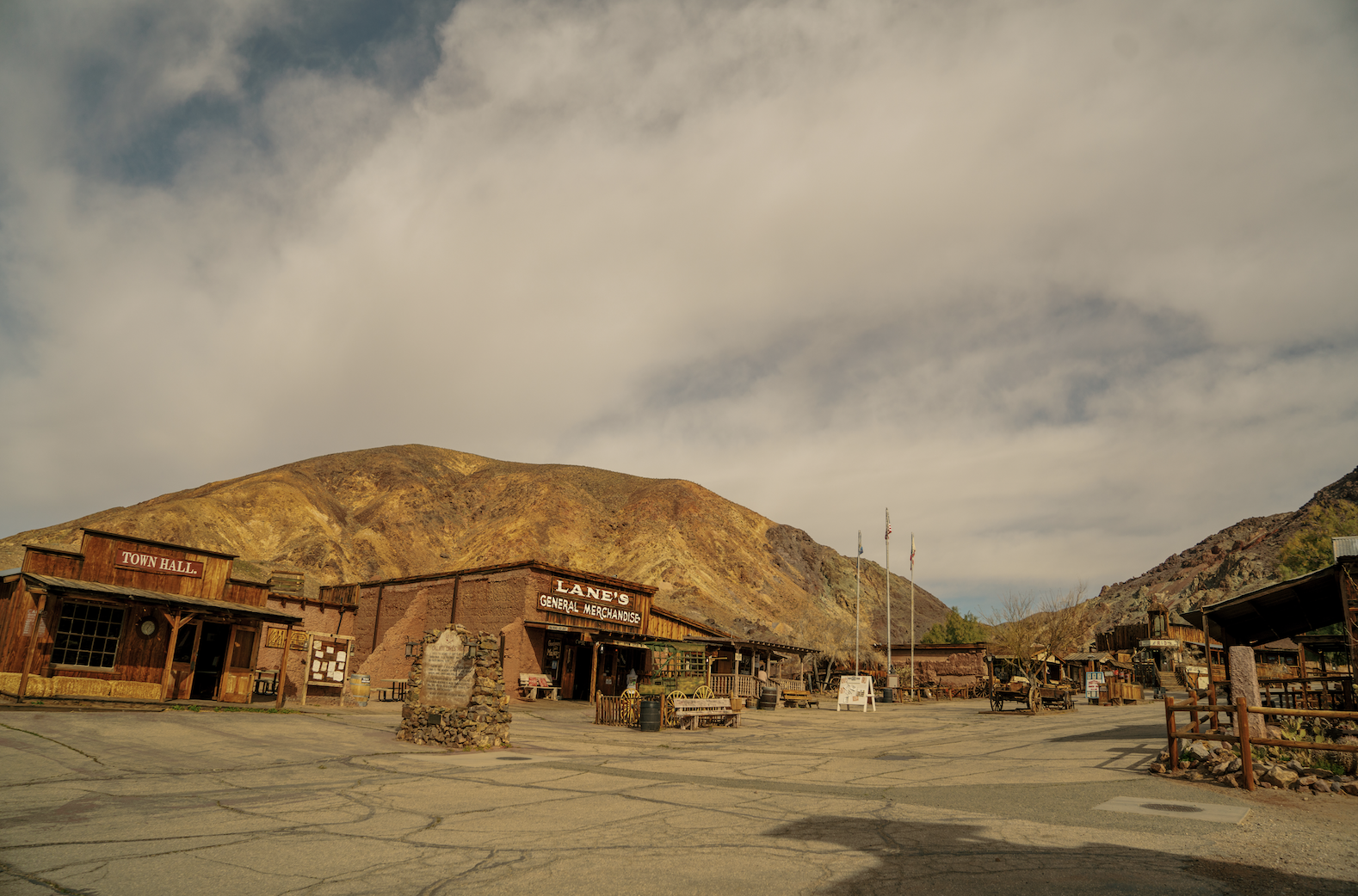Calico Ghost Town from the parking lot, with old wooden buildings and large brown hills in the background