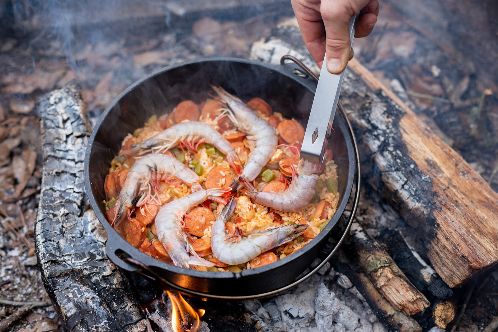 Adding in tomato sauce to the jambalaya.