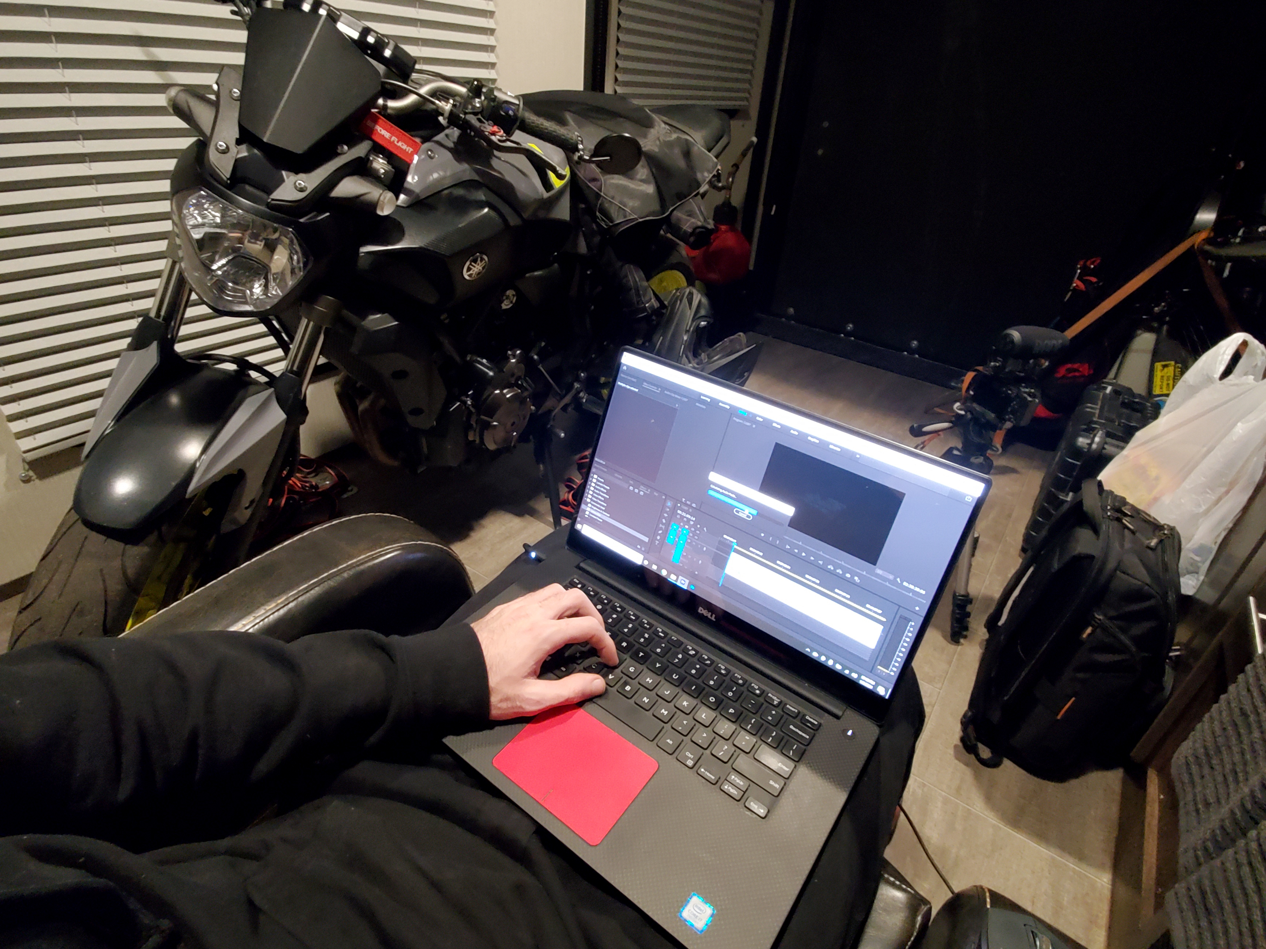 Tucker Gott edits a film on his computer in the garage of his Cruiser Stryker RV.