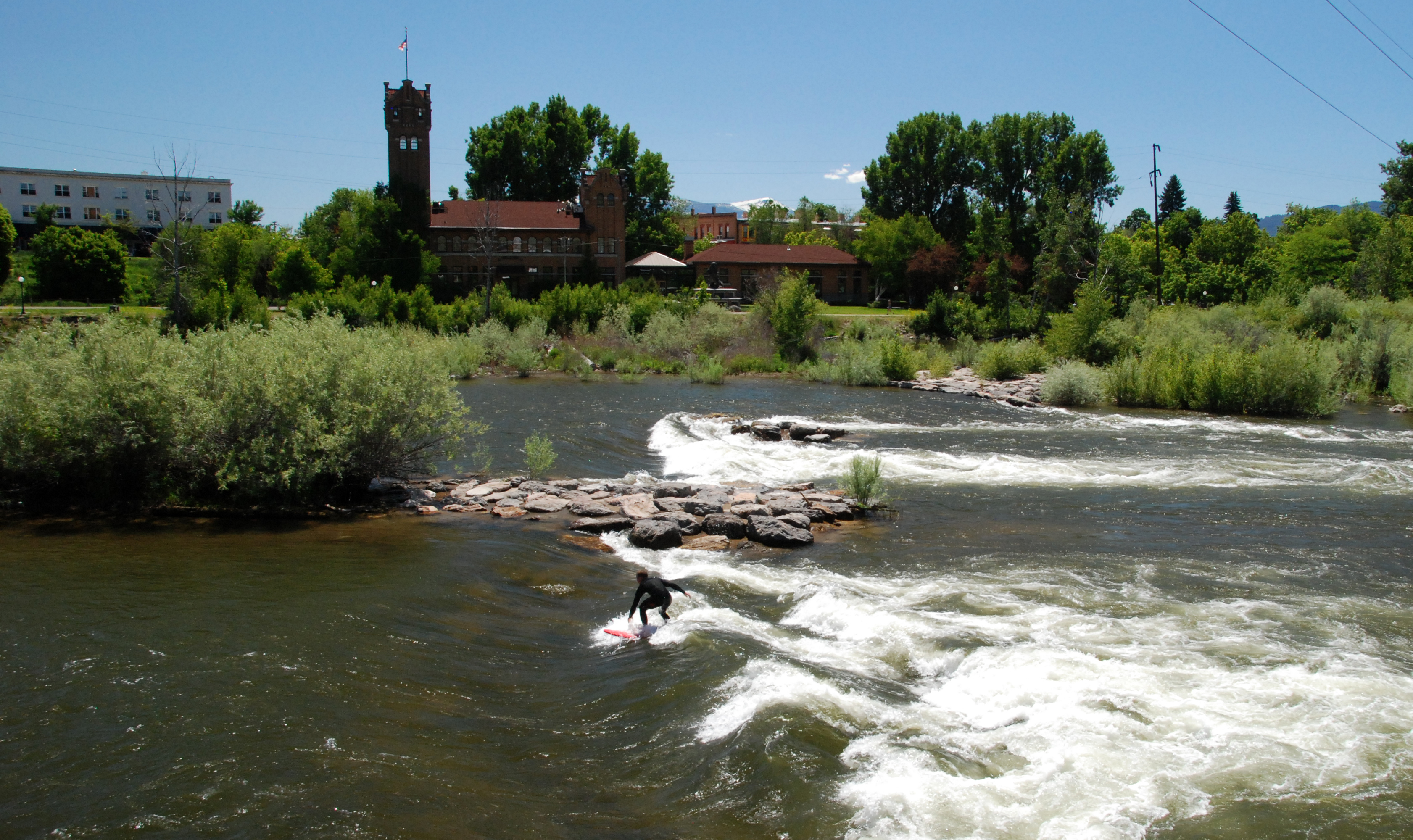 Eric Hannan surfing in a river.