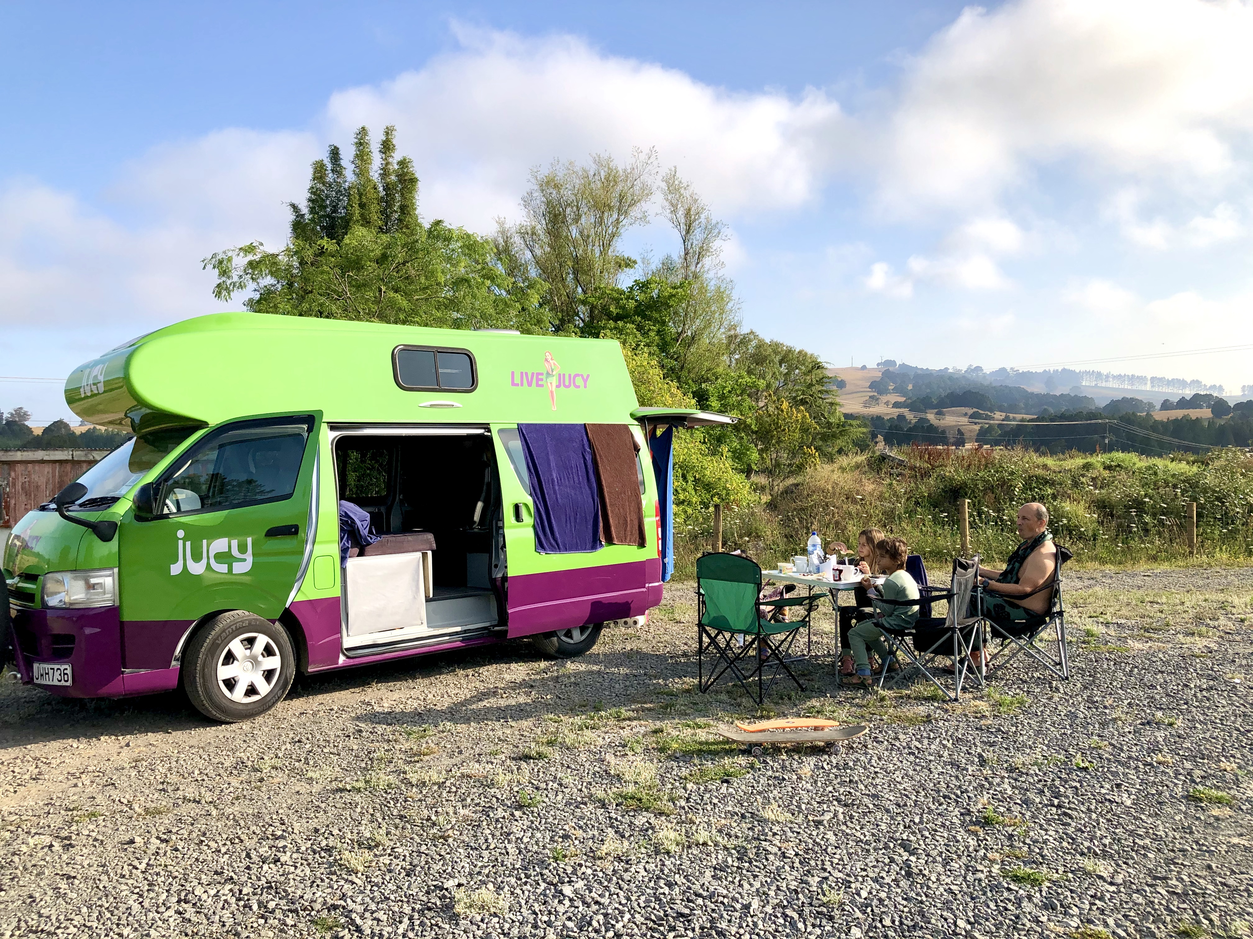 LAURA GEORGIEFF's family sitting outside of a rented Class B RV