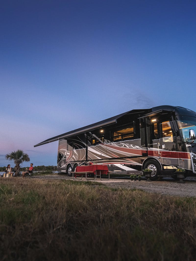 An Entegra Class A motorhome parked by the beach