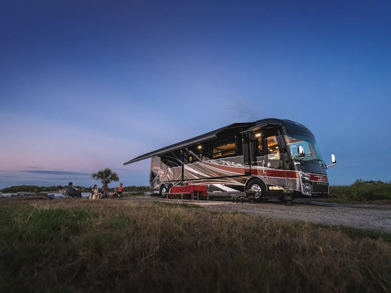 An Entegra Class A motorhome parked by the beach