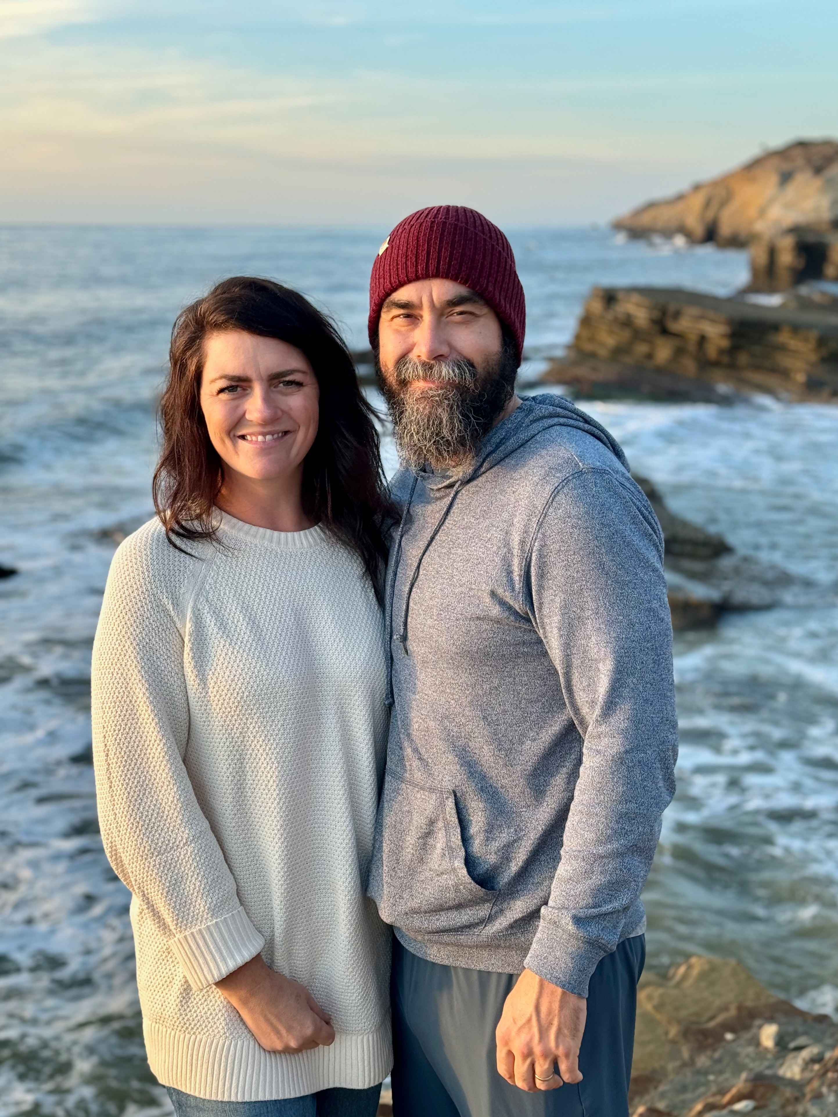 Melissa and Lucas Lahr pose near a scenic ocean overlook.