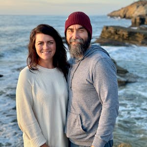 Melissa and Lucas Lahr pose near a scenic ocean overlook.