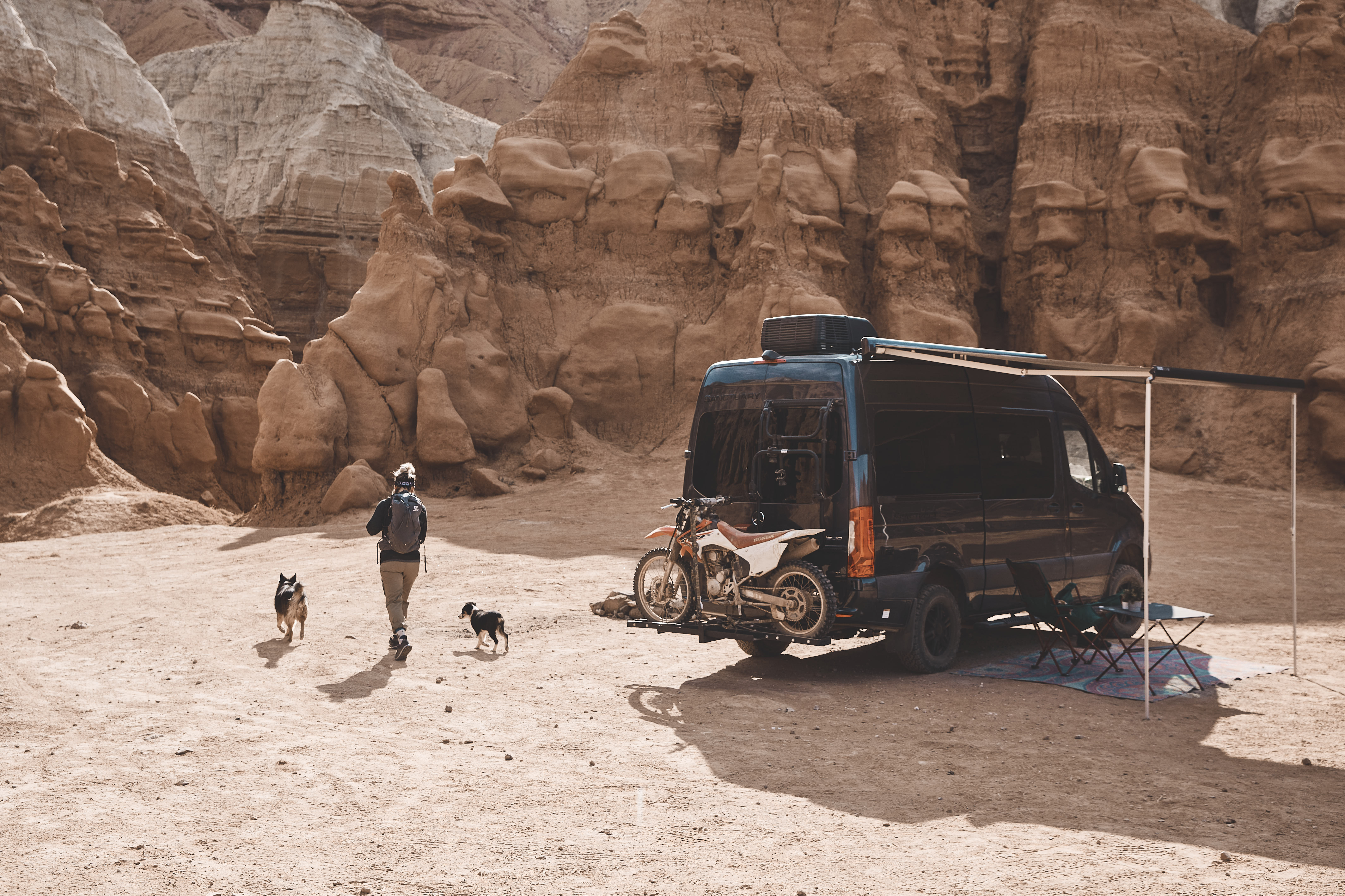 Kalen Thorien walking away from the Thor Motor Coach Sequence with two dogs