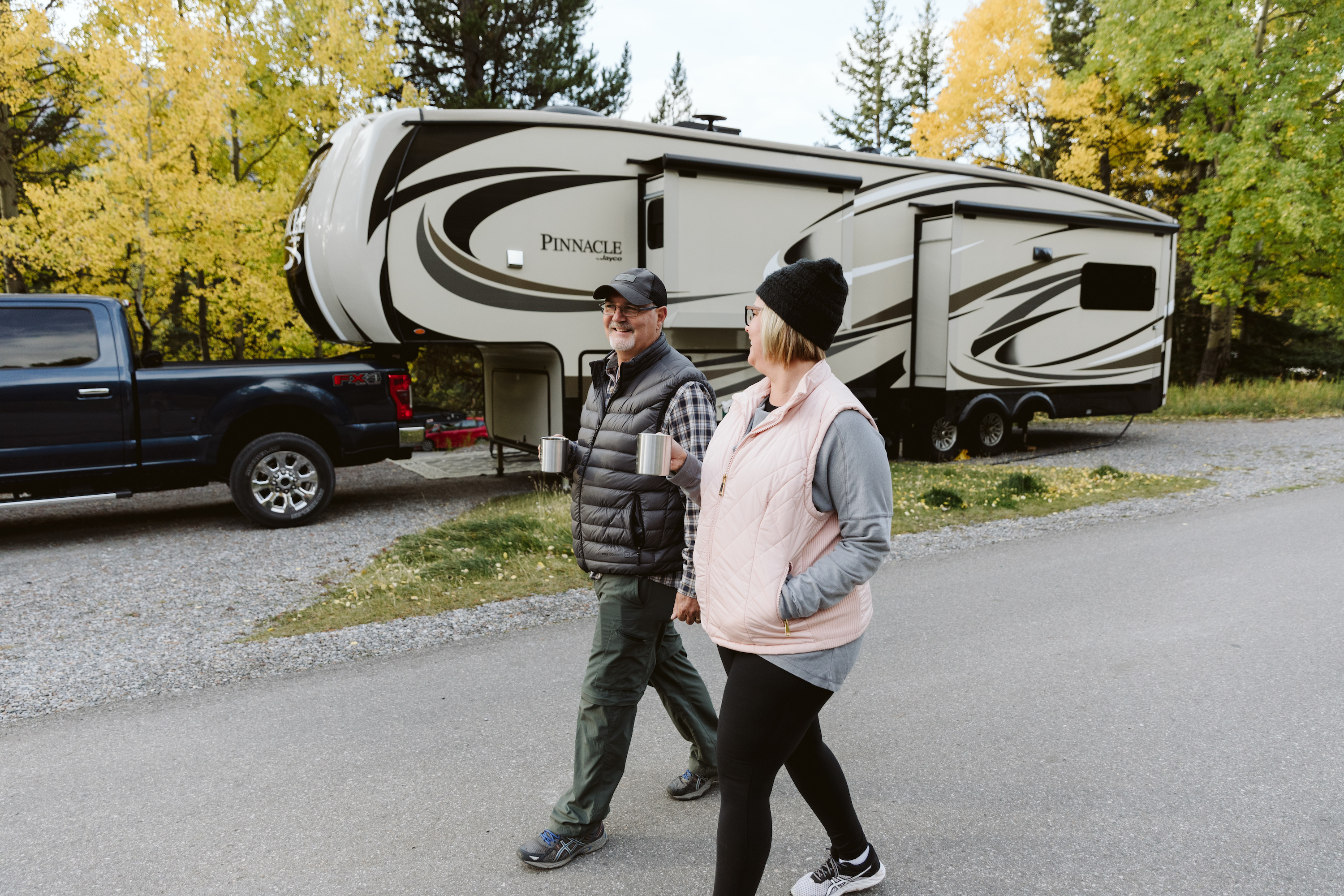 Tina and Craig walking together in a campground. 