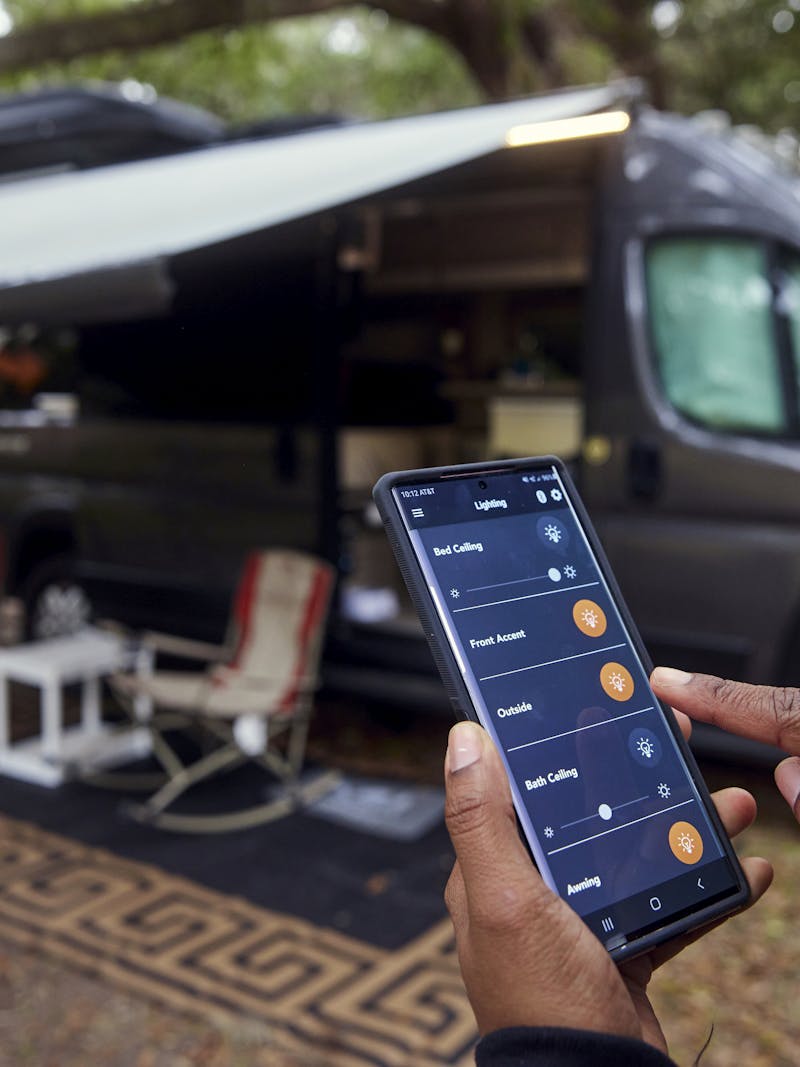 Rocio Rivero using an app on her phone to turn on a light on her RV