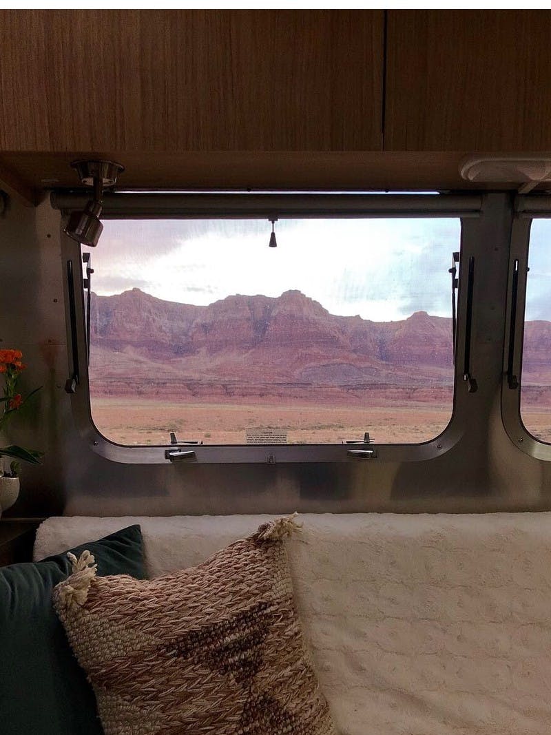 A view from the inside of an RV looking out the window to the Vermillion Cliffs of Arizona.