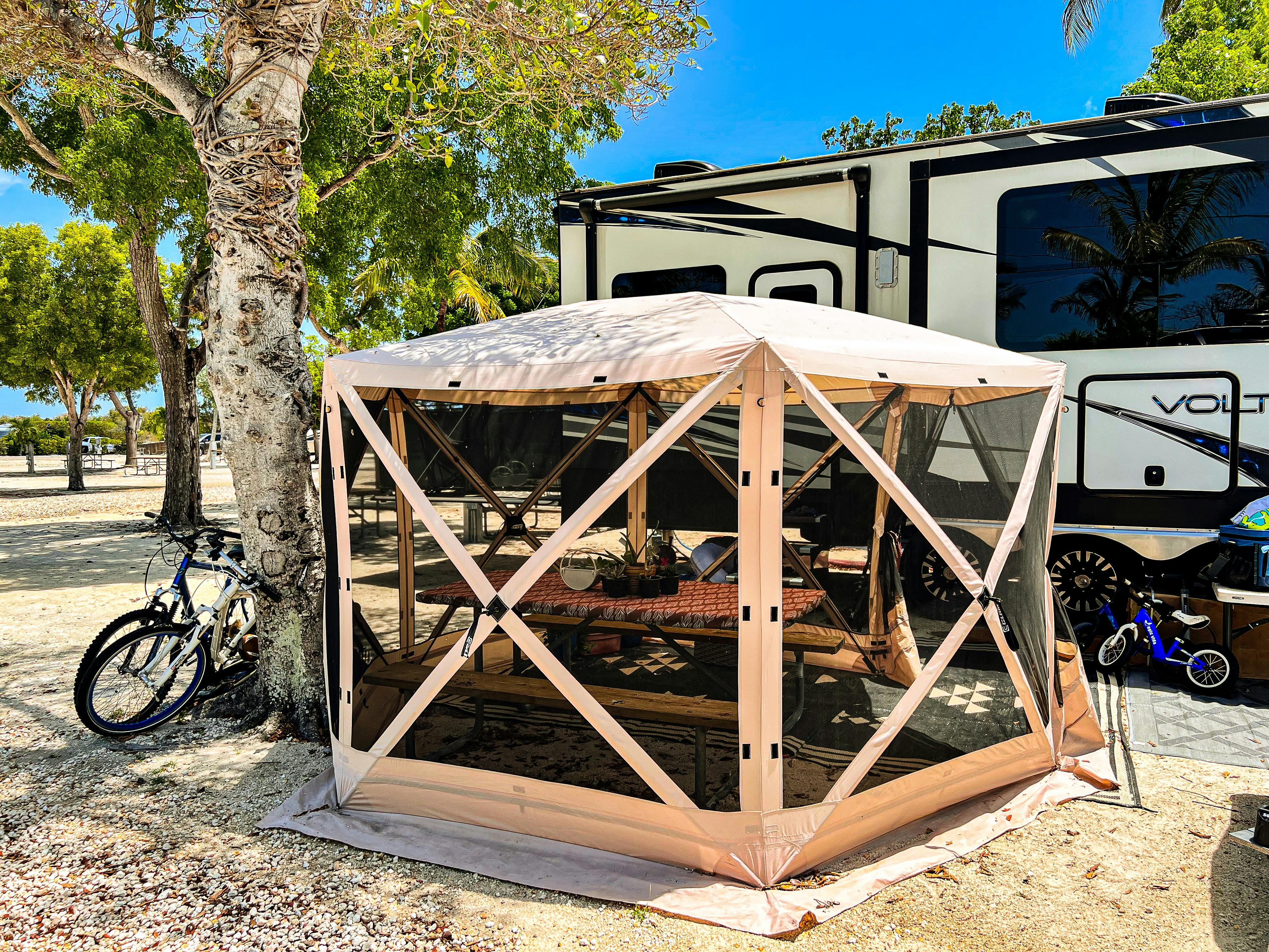 Samantha Edmunds shows a tent covering a picnic table at a campsite